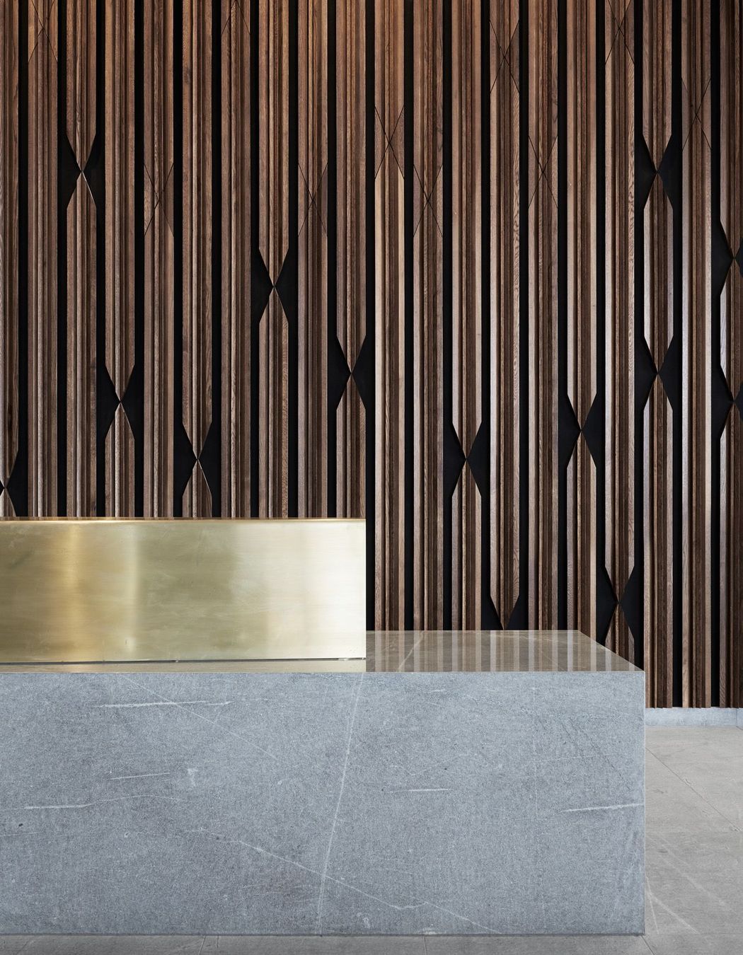 Materials on the ground floor are distilled to stone, timber and brass. 