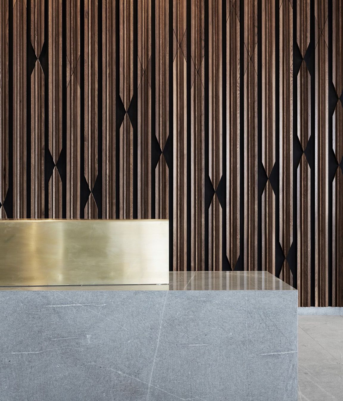 Materials on the ground floor are distilled to stone, timber and brass. 