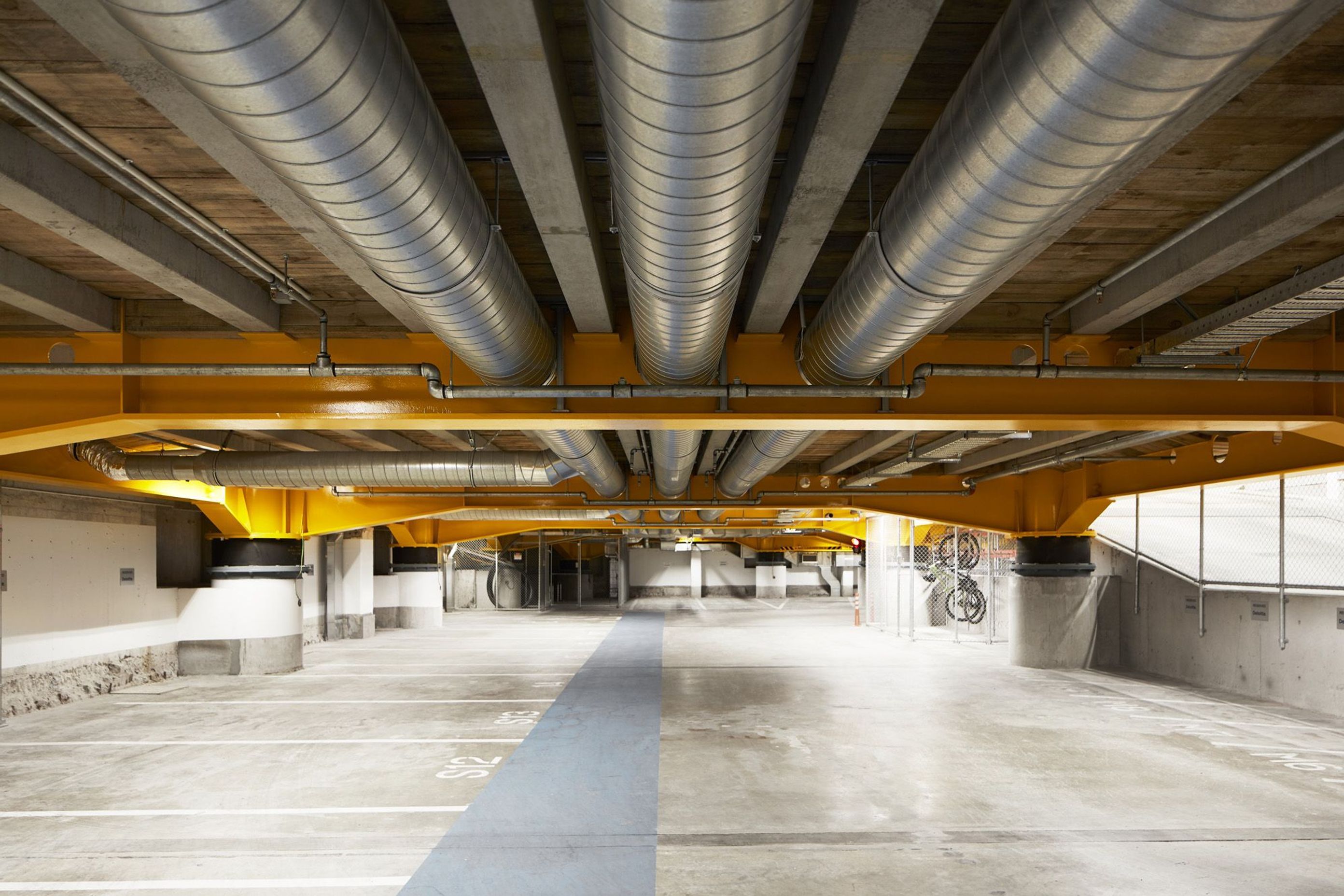 In the basement, the base isolators hold the weight of the building and allow the foundations to move sideways.