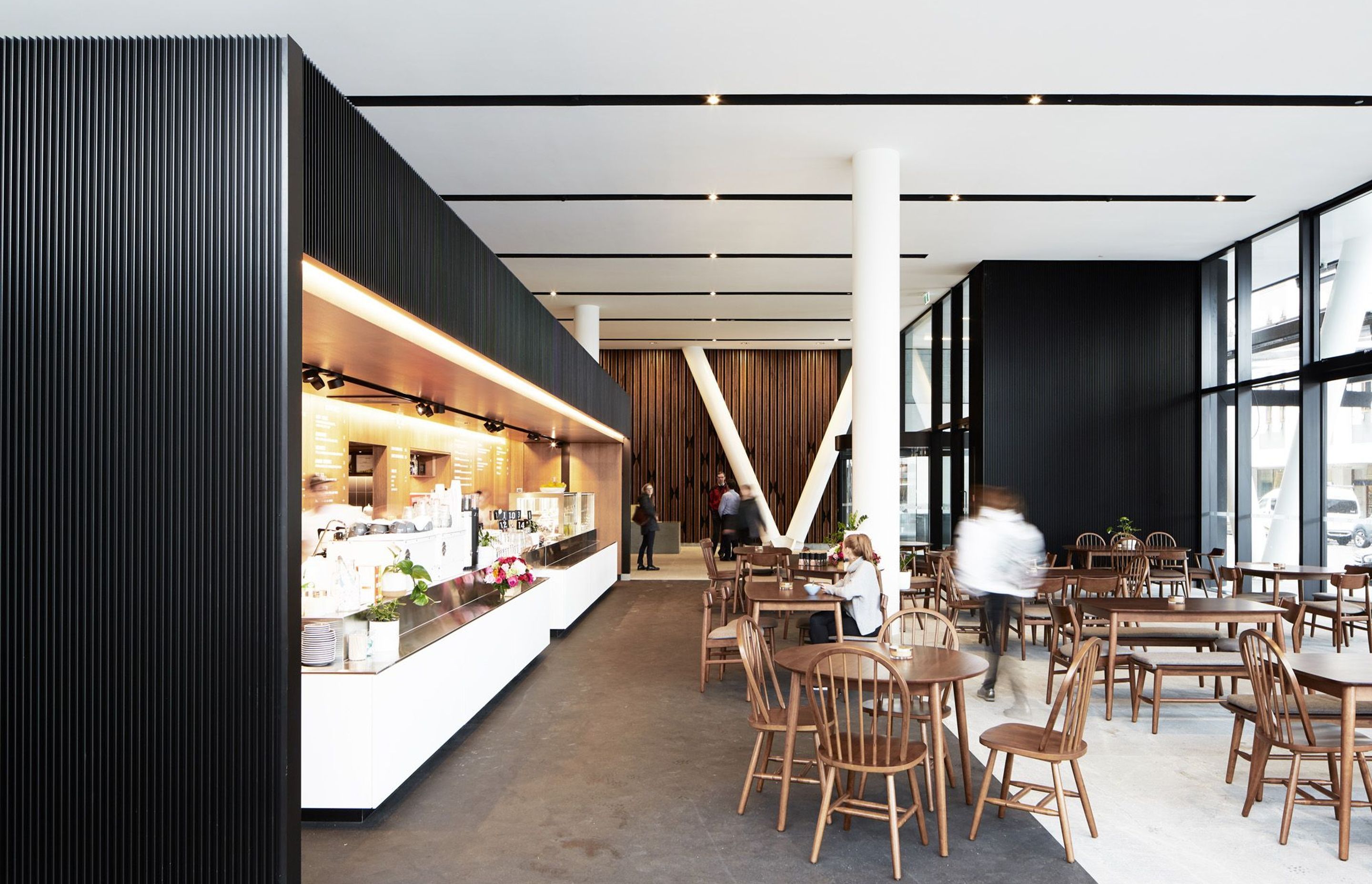 The café in the ground-floor atrium also acts as an informal work space for meetings.