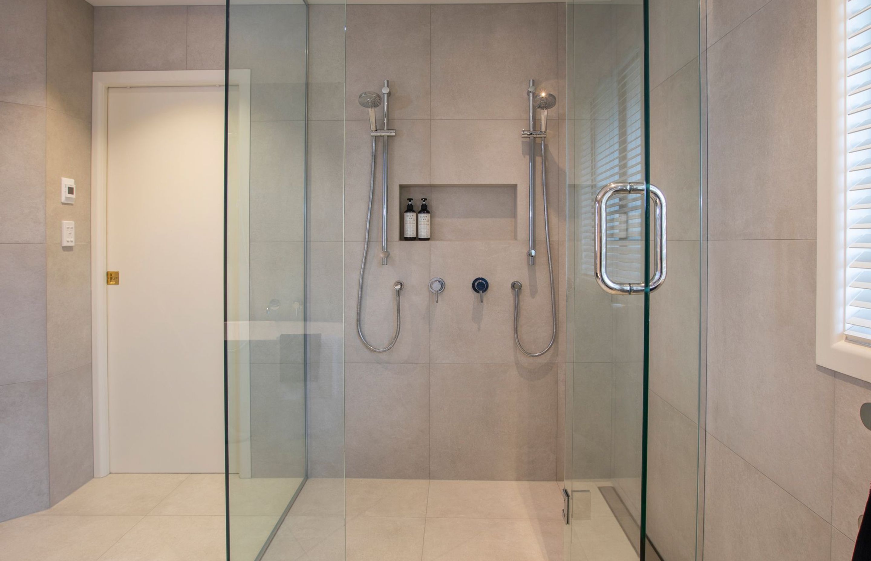 Large custom shower for maximum useability and practicality with the addition of a tiled recess shelf.
