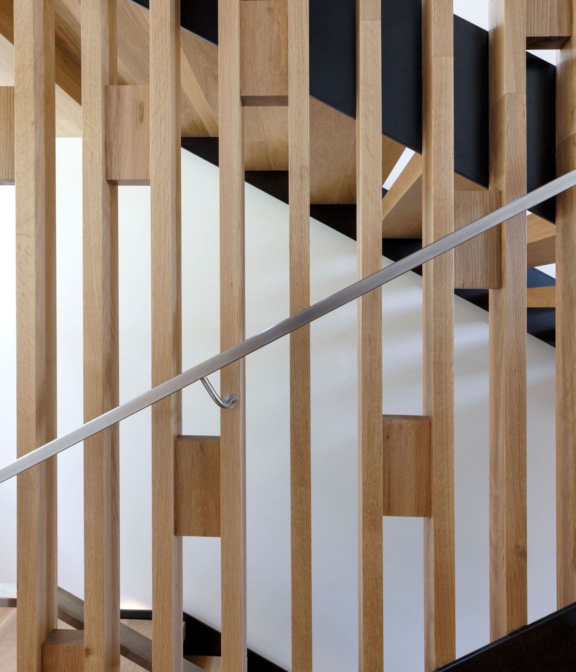 Timber blocks add bracing and pattern to the balustrade of the staircase.