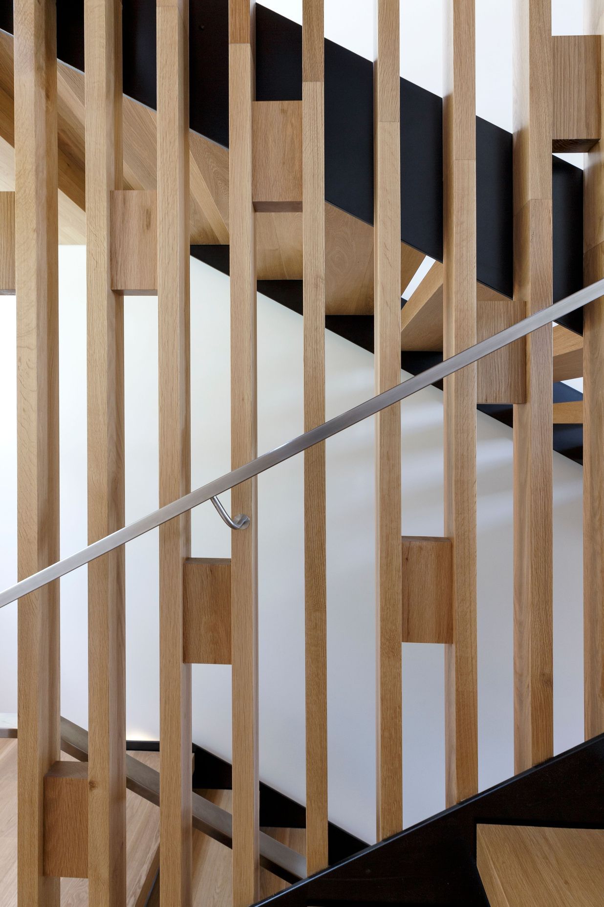 Timber blocks add bracing and pattern to the balustrade of the staircase.