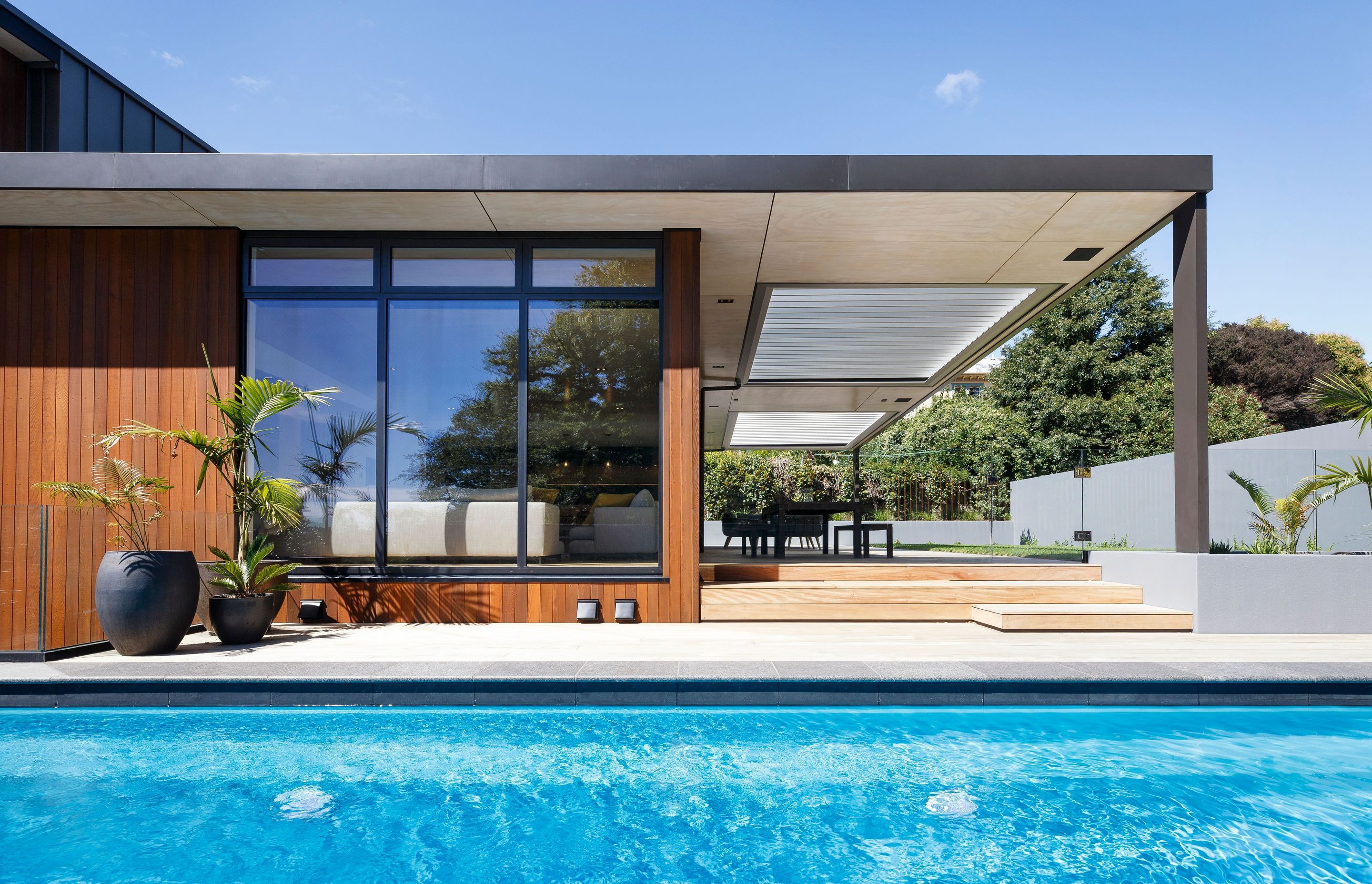 The lounge and outdoor dining area viewed from the pool.