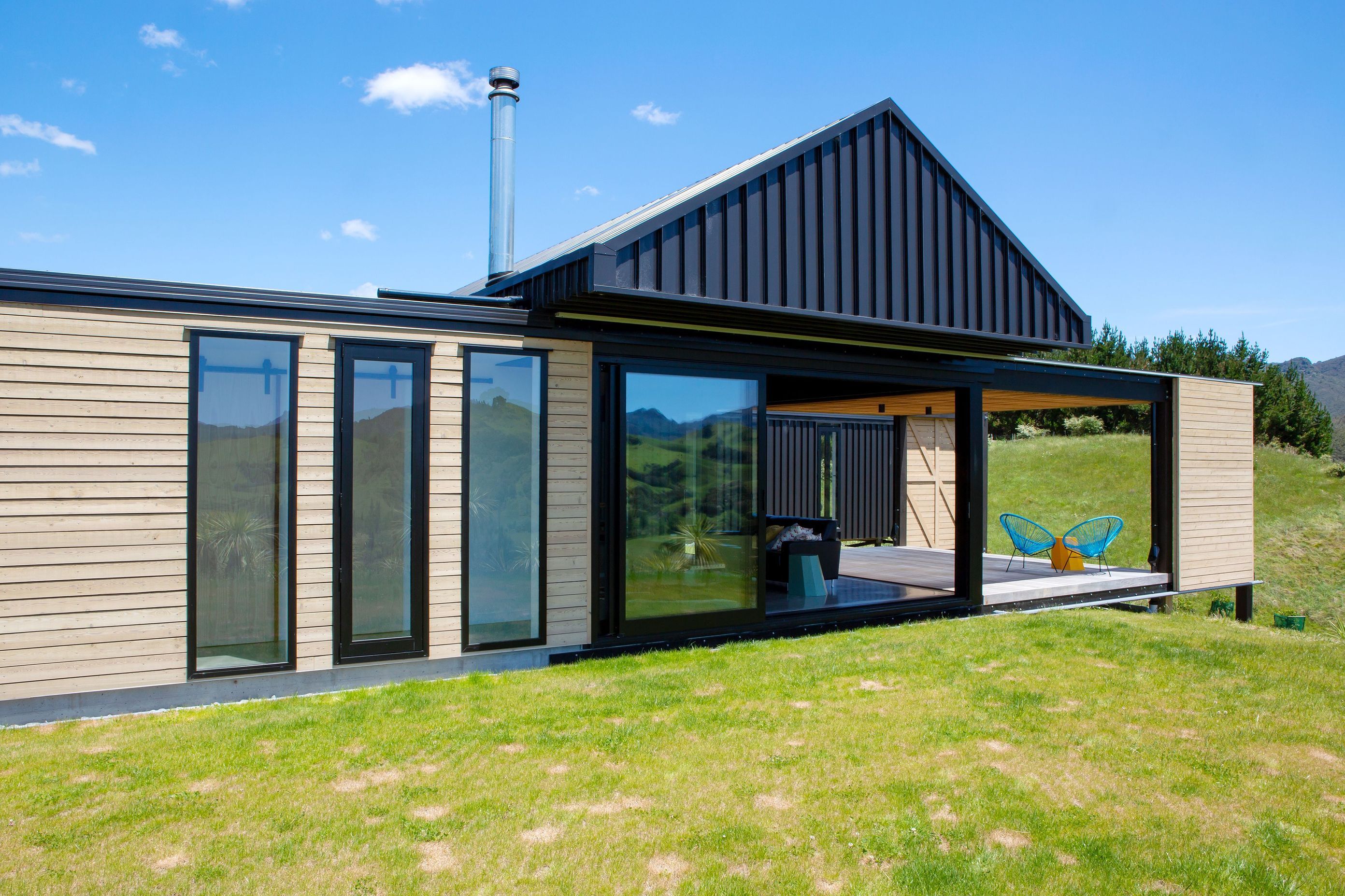 This house is comprised of two rectangular structures, one clad in larch while the other in long run steel. 