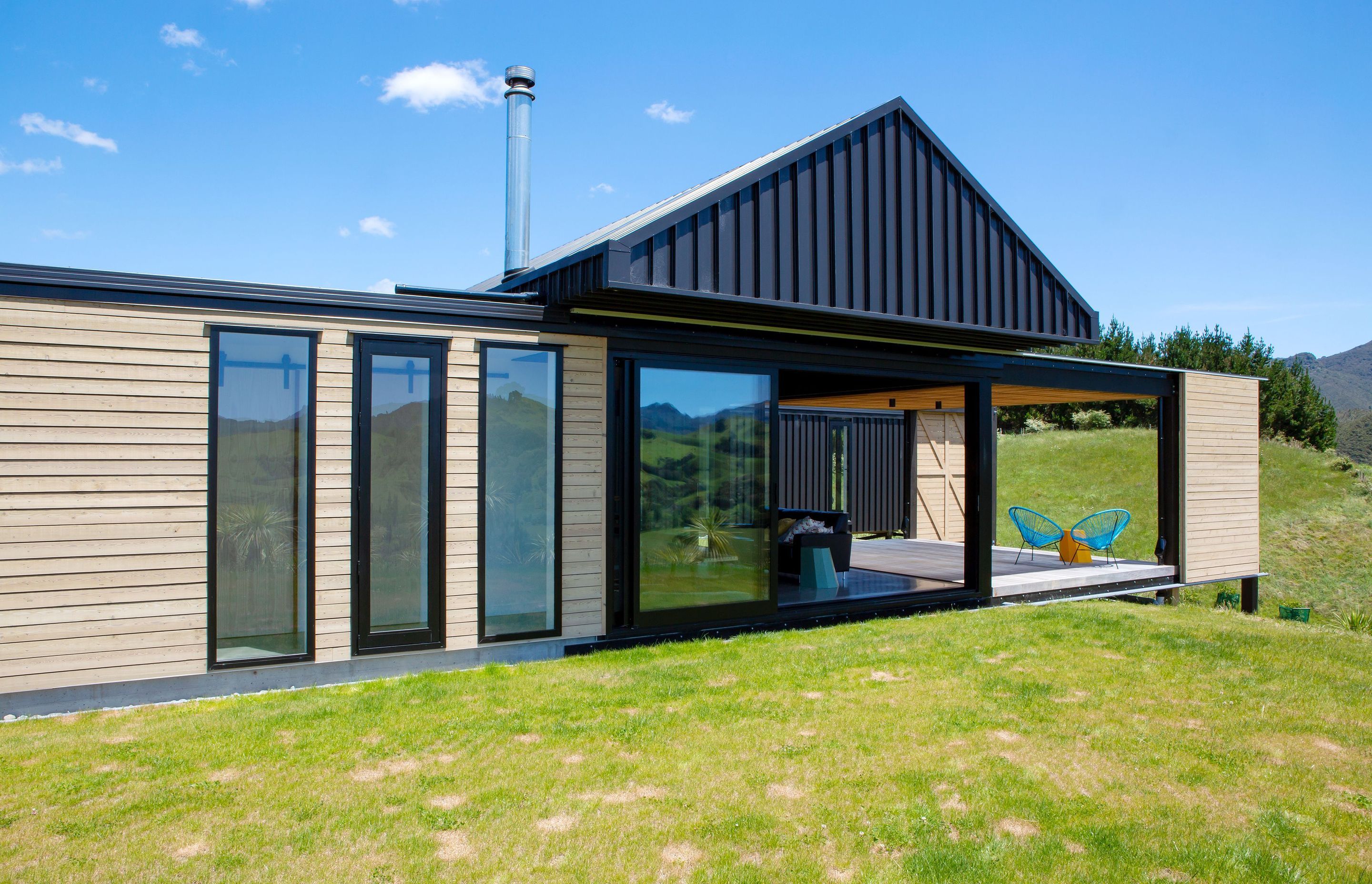 This house is comprised of two rectangular structures, one clad in larch while the other in long run steel. 