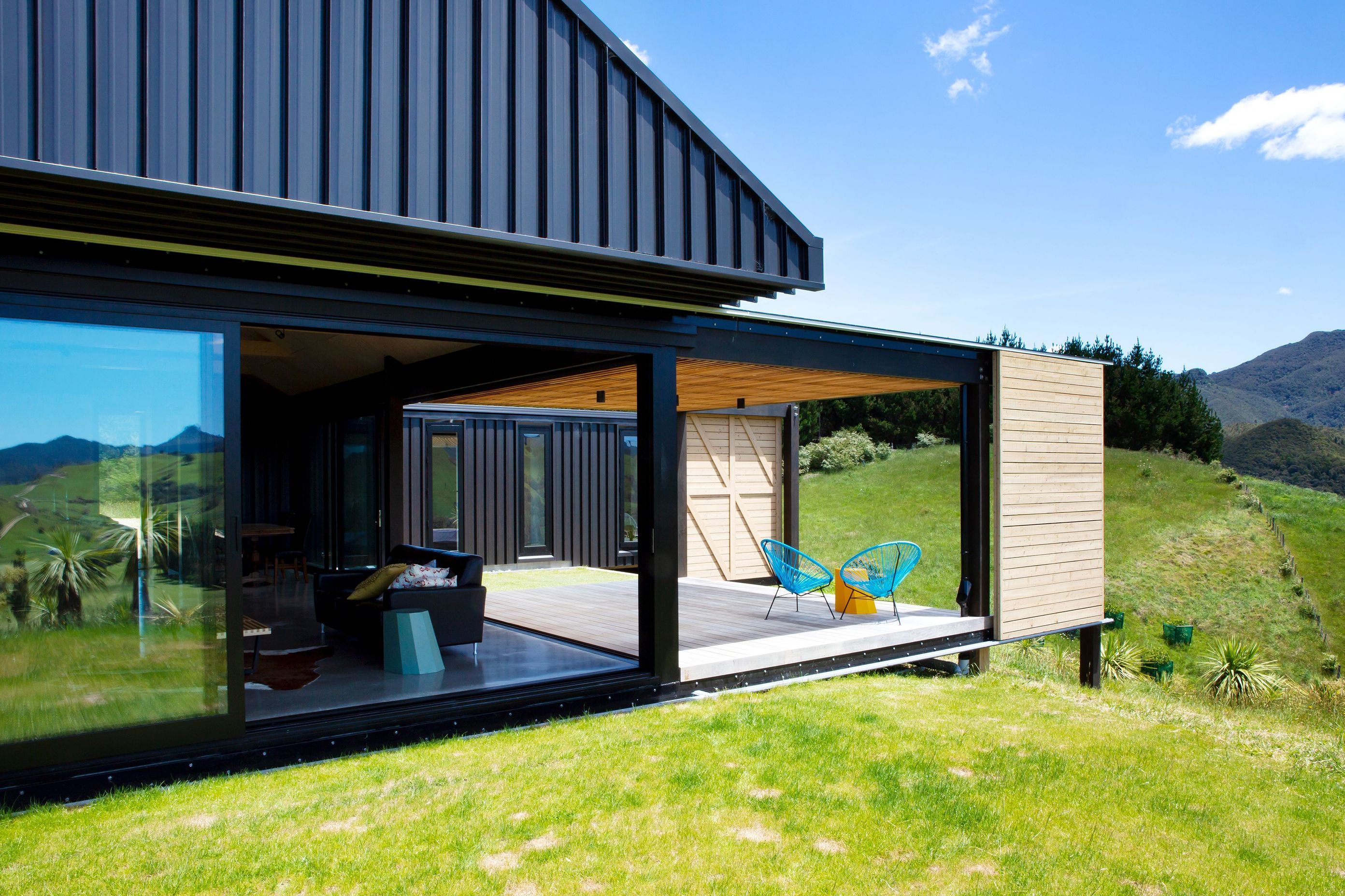 A floating gabled roof encloses a central pavillion containing the public spaces of the house, the kitchen, dining and living area from which a covered deck extends out to the west. 