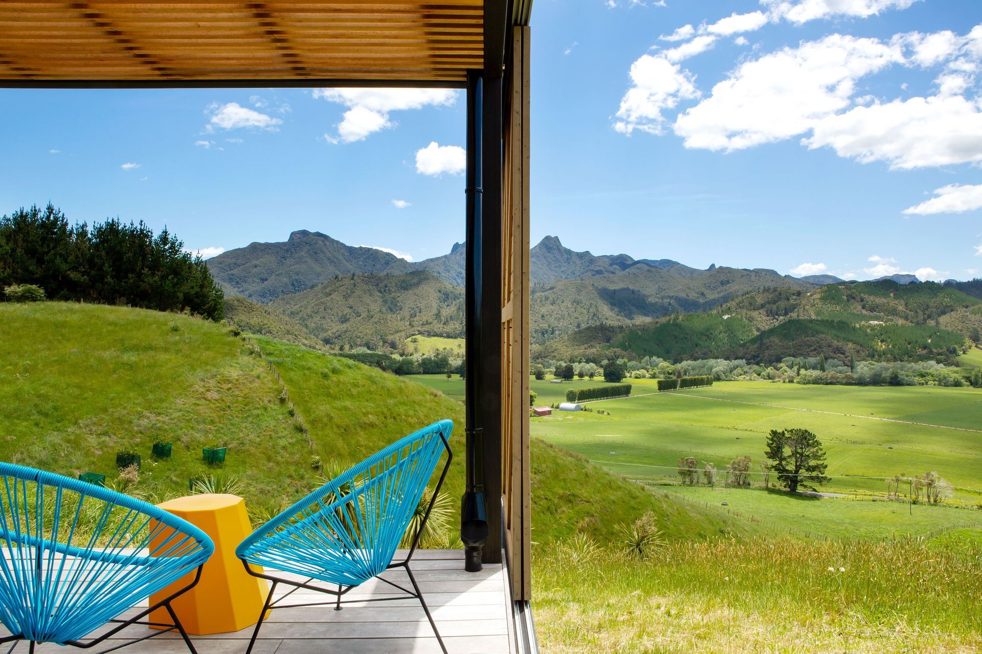 A cedar batten ceiling conceals a translucent roofing sheet above the deck that allows dappled light into the area when the sun is high.