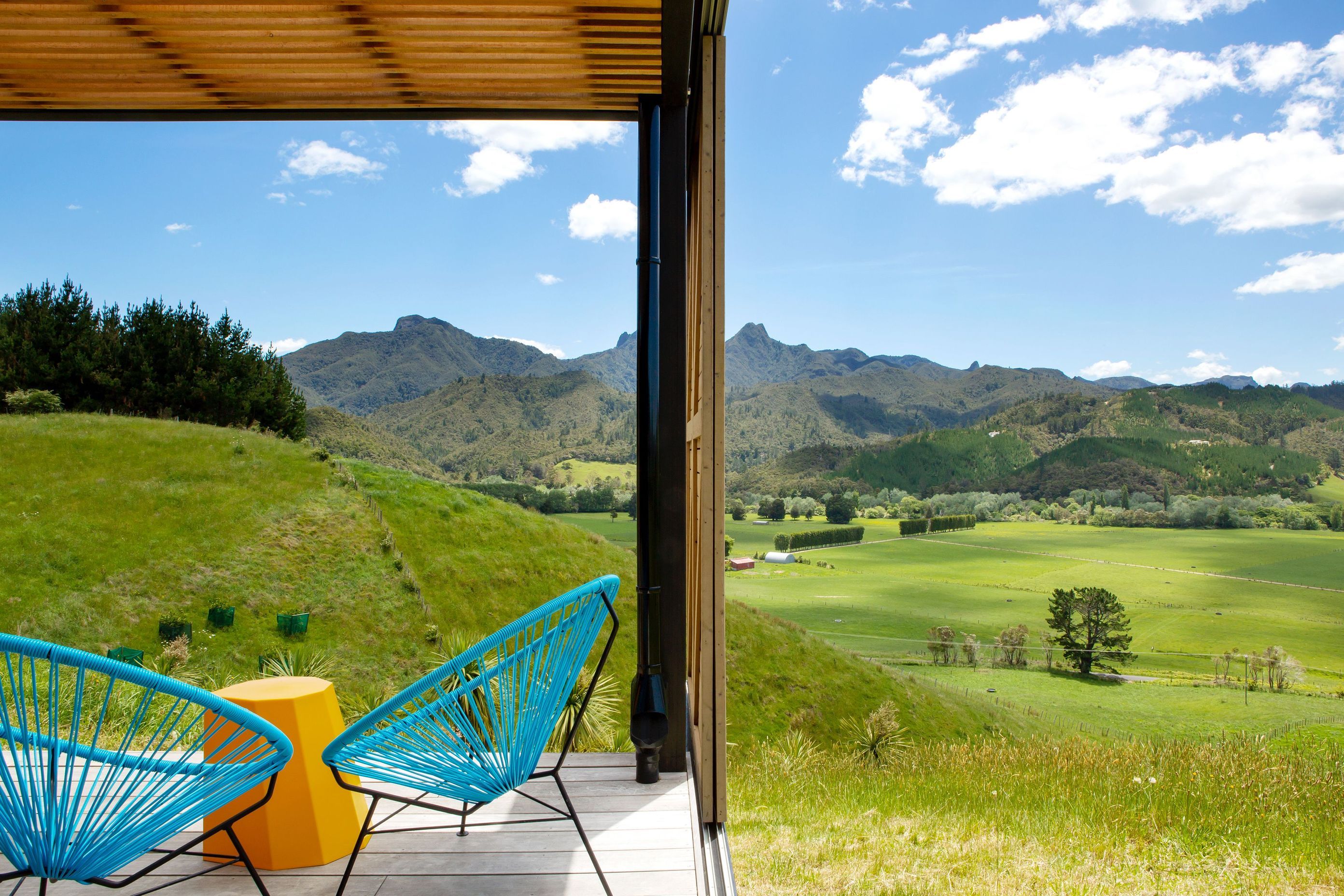A cedar batten ceiling conceals a translucent roofing sheet above the deck that allows dappled light into the area when the sun is high. 