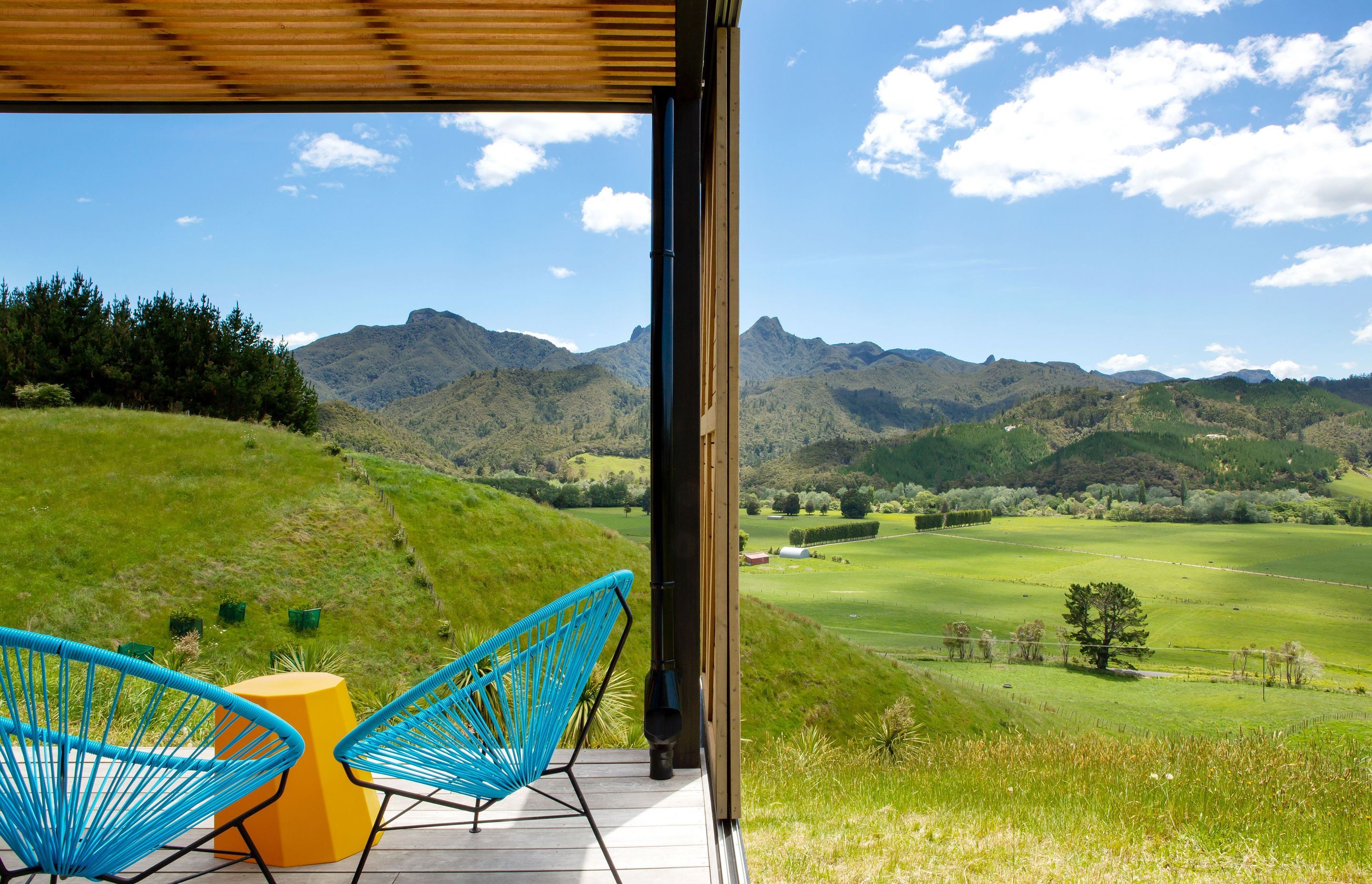 A cedar batten ceiling conceals a translucent roofing sheet above the deck that allows dappled light into the area when the sun is high. 