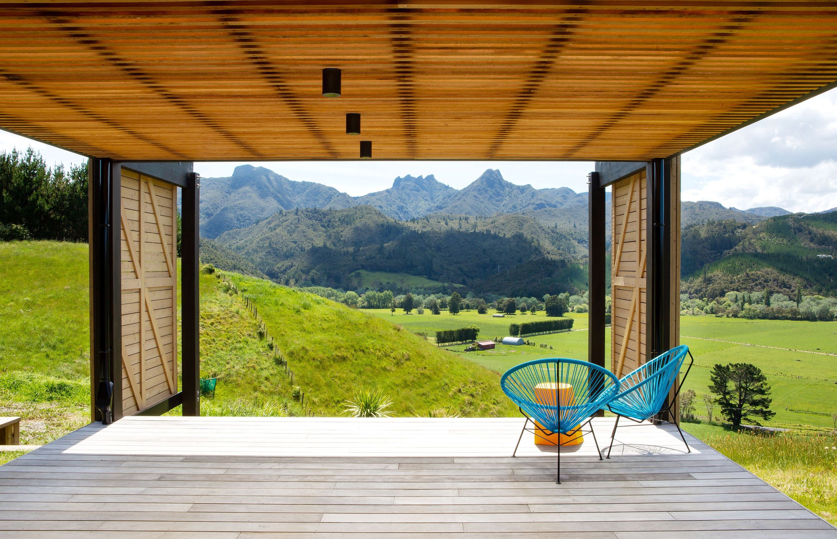 Looking out to The Pinnacles, this covered deck is one of two outdoor living options offering close connection to the land and views.