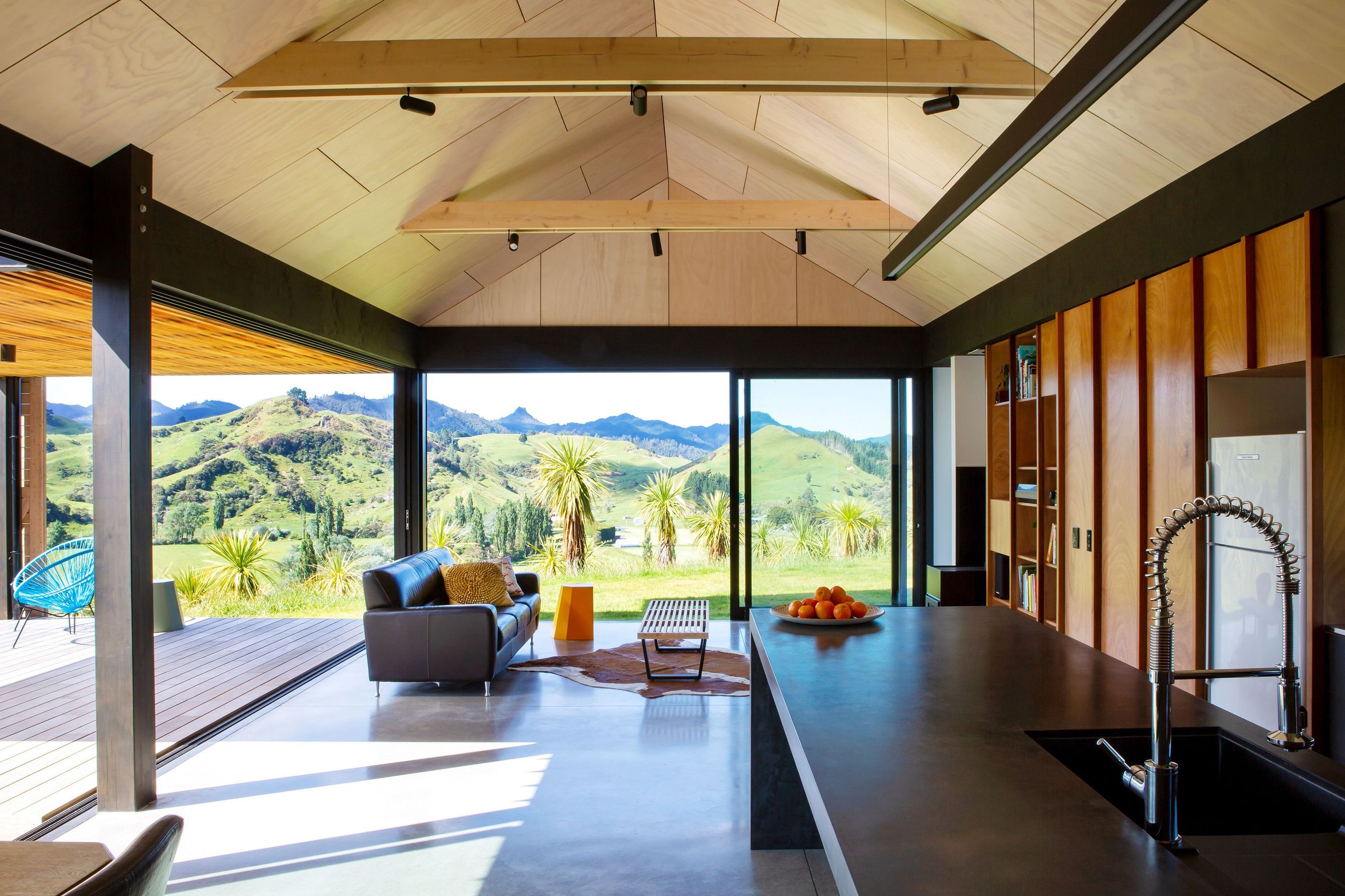 Timber cabinetry with cedar handles highlights the connection between external and internal material palettes.
