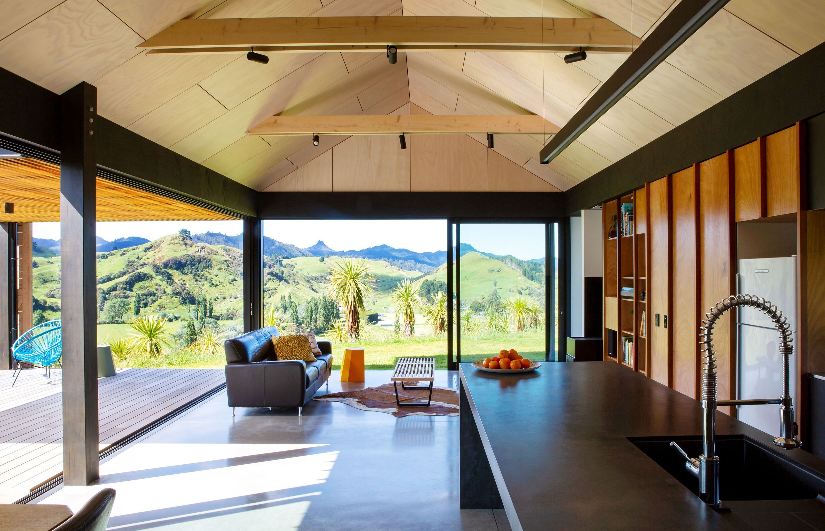 Timber cabinetry with cedar handles highlights the connection between external and internal material palettes.