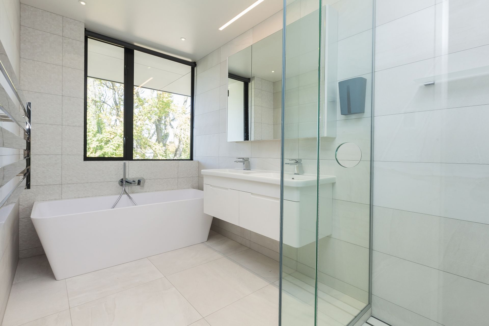 The guest bathroom features an all-white scheme for a light, bright and airy feel.