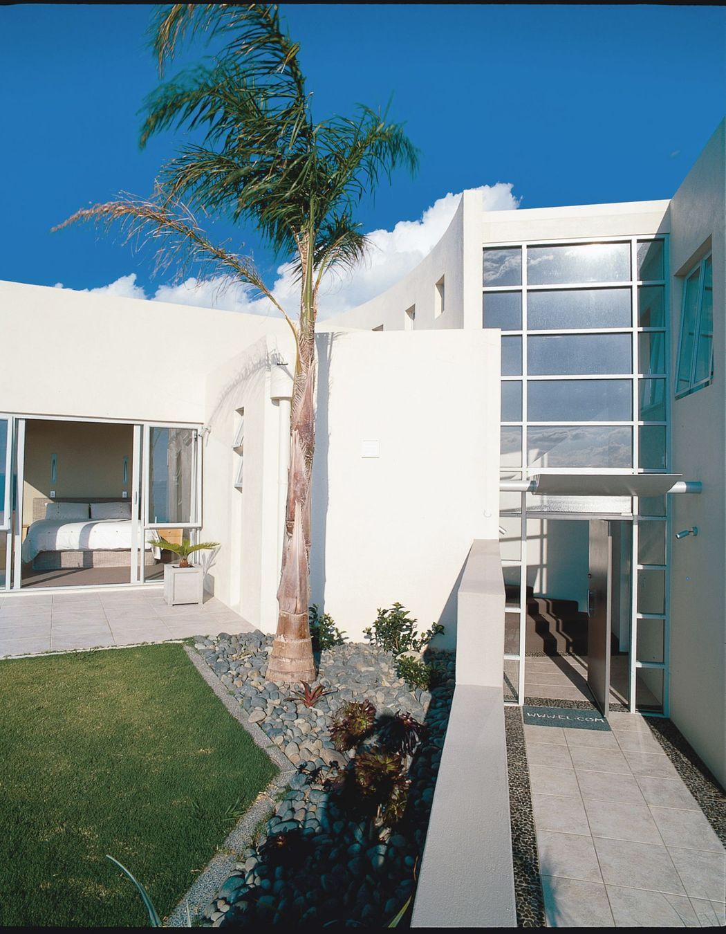 The curved stair is the spine of the home separating Owners' suite and Guest rooms before arrival at a 270 degree view