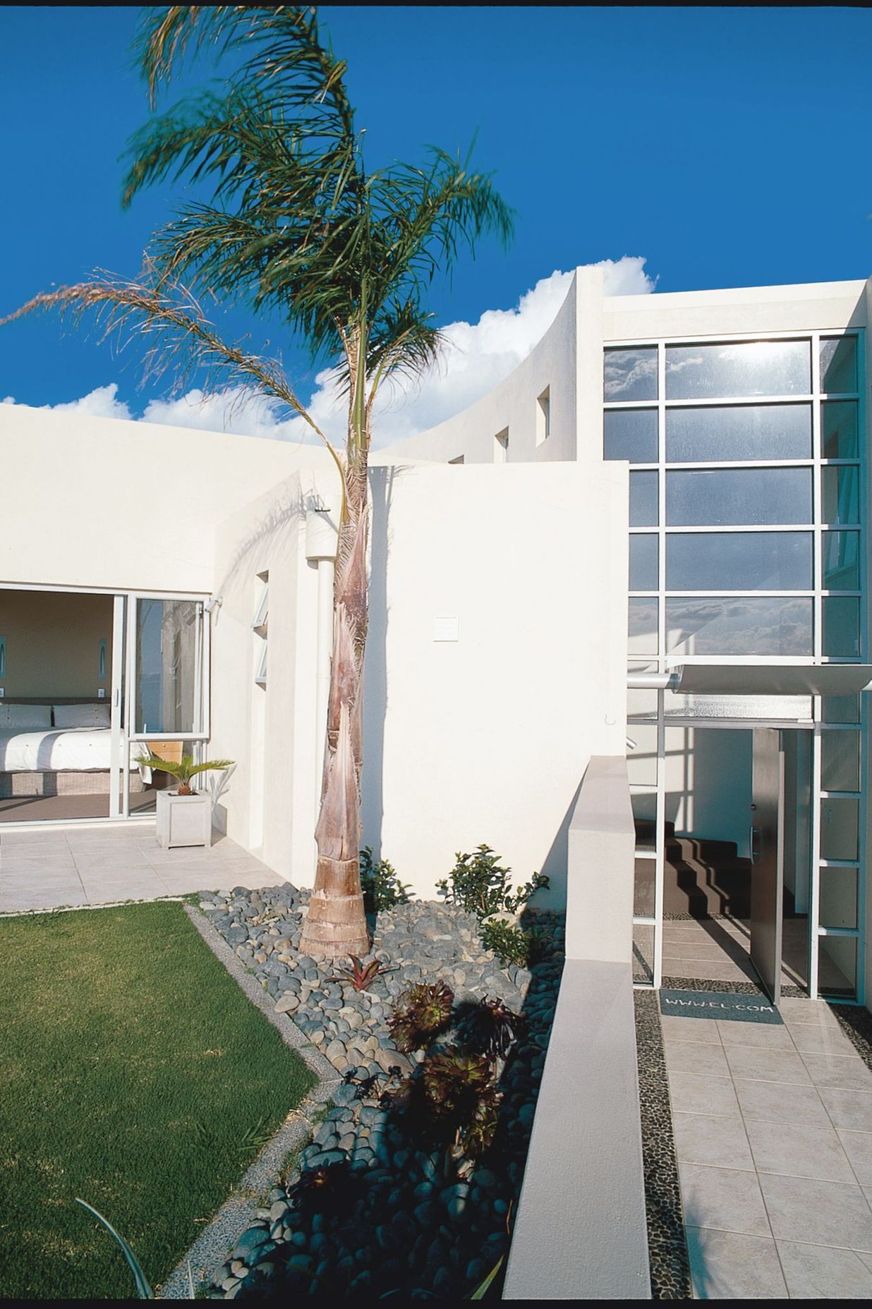 The curved stair is the spine of the home separating Owners' suite and Guest rooms before arrival at a 270 degree view