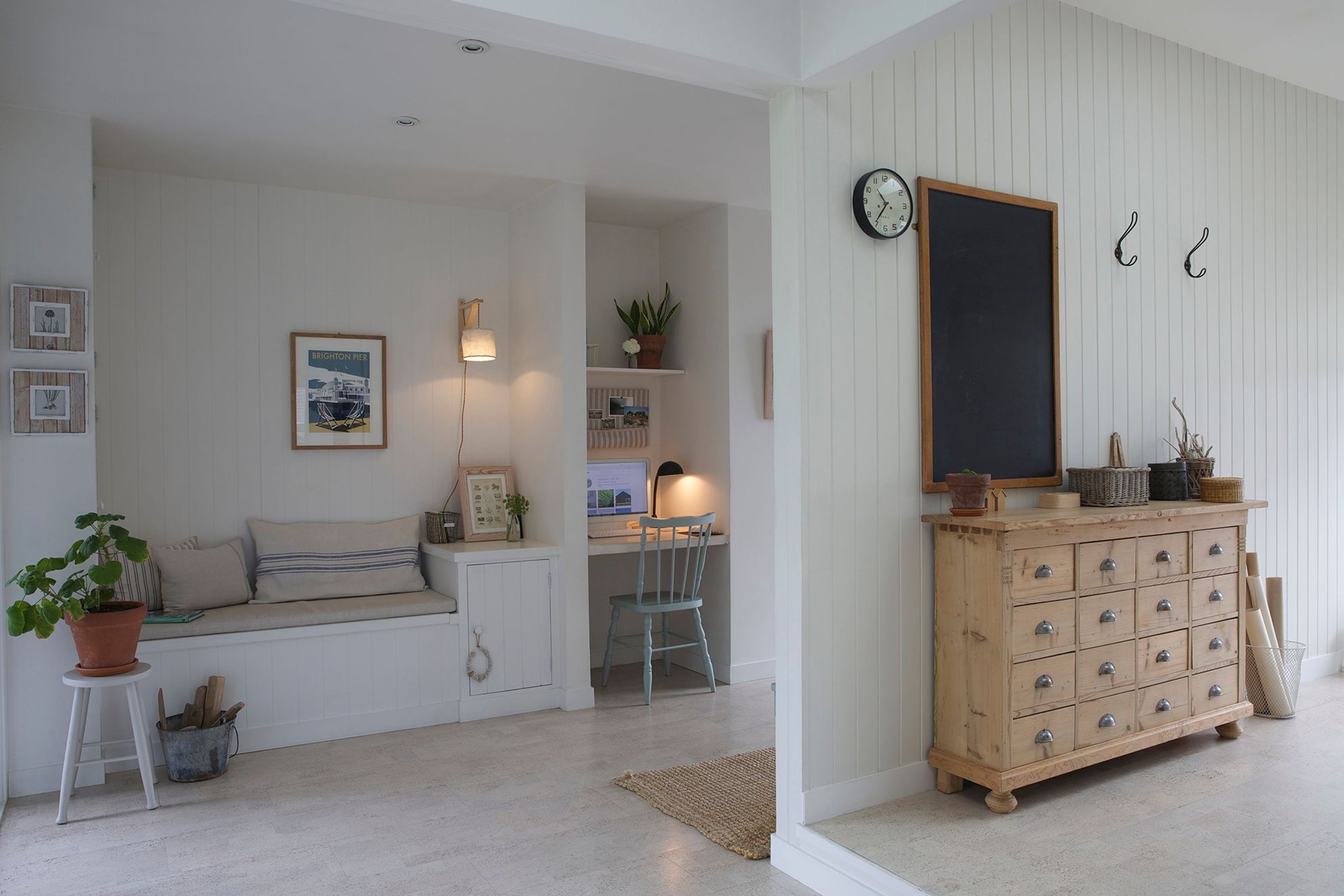 A built-in desk and reading nook on the left and leads into the sewing studio on the right.