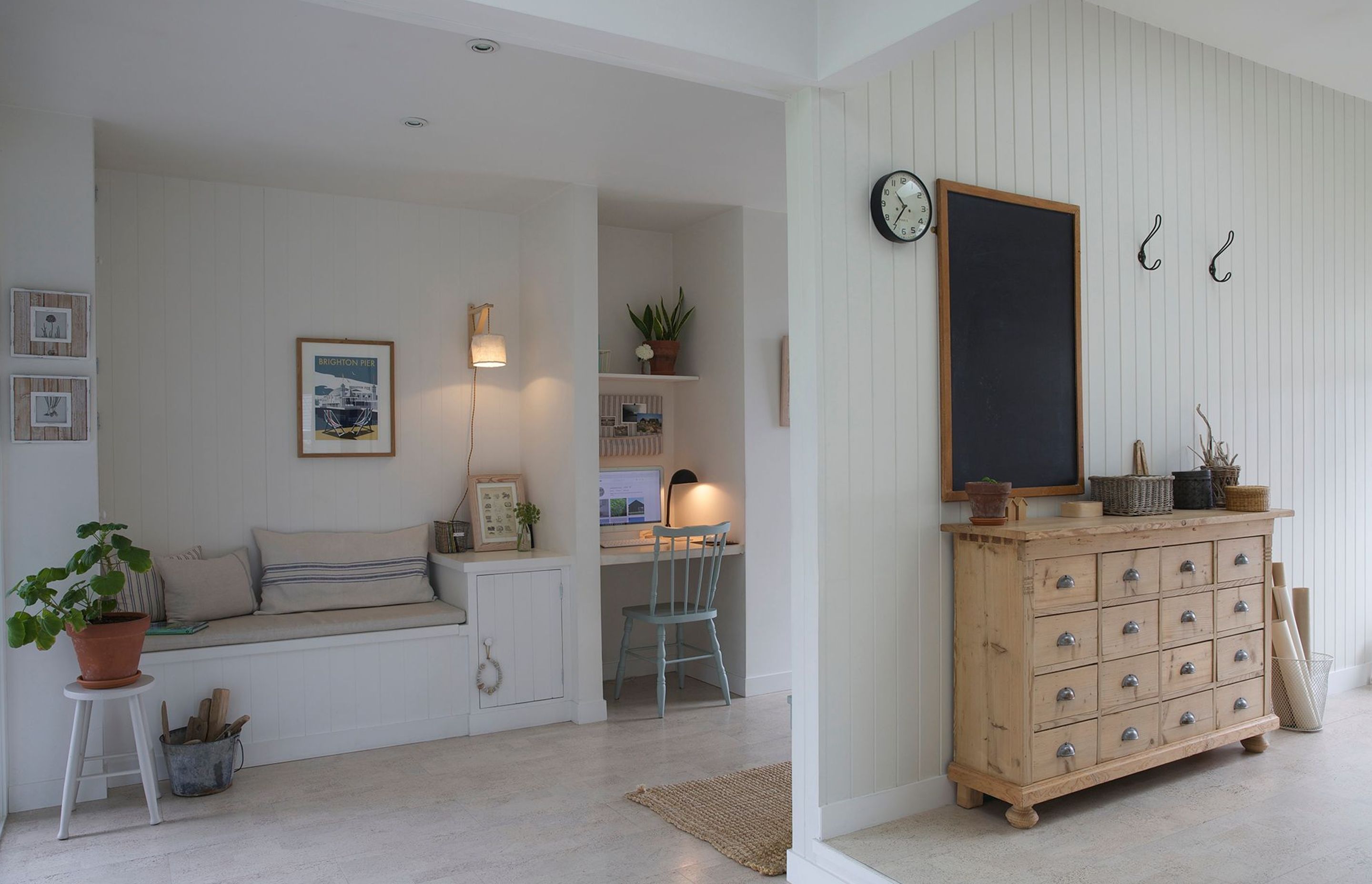 A built-in desk and reading nook on the left and leads into the sewing studio on the right.