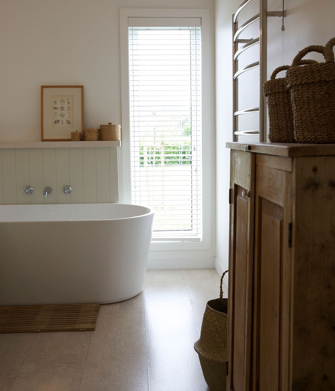 Tall vertical windows are a feature of this home, seen here in the bathroom.