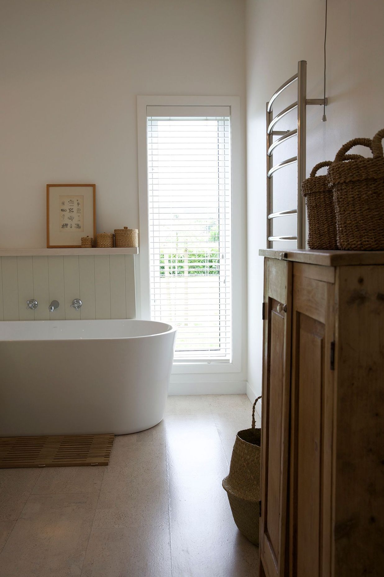 Tall vertical windows are a feature of this home, seen here in the bathroom.