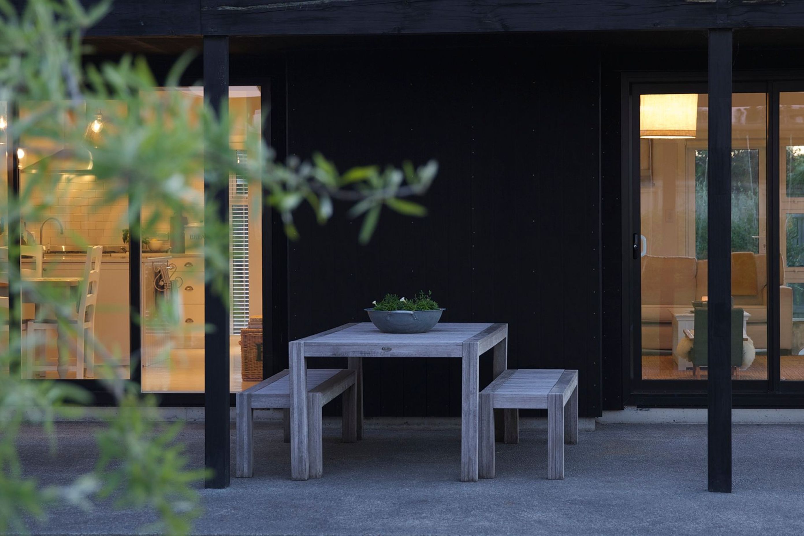 The sheltered outdoor dining area enjoys views of the rural Wairarapa landscape.