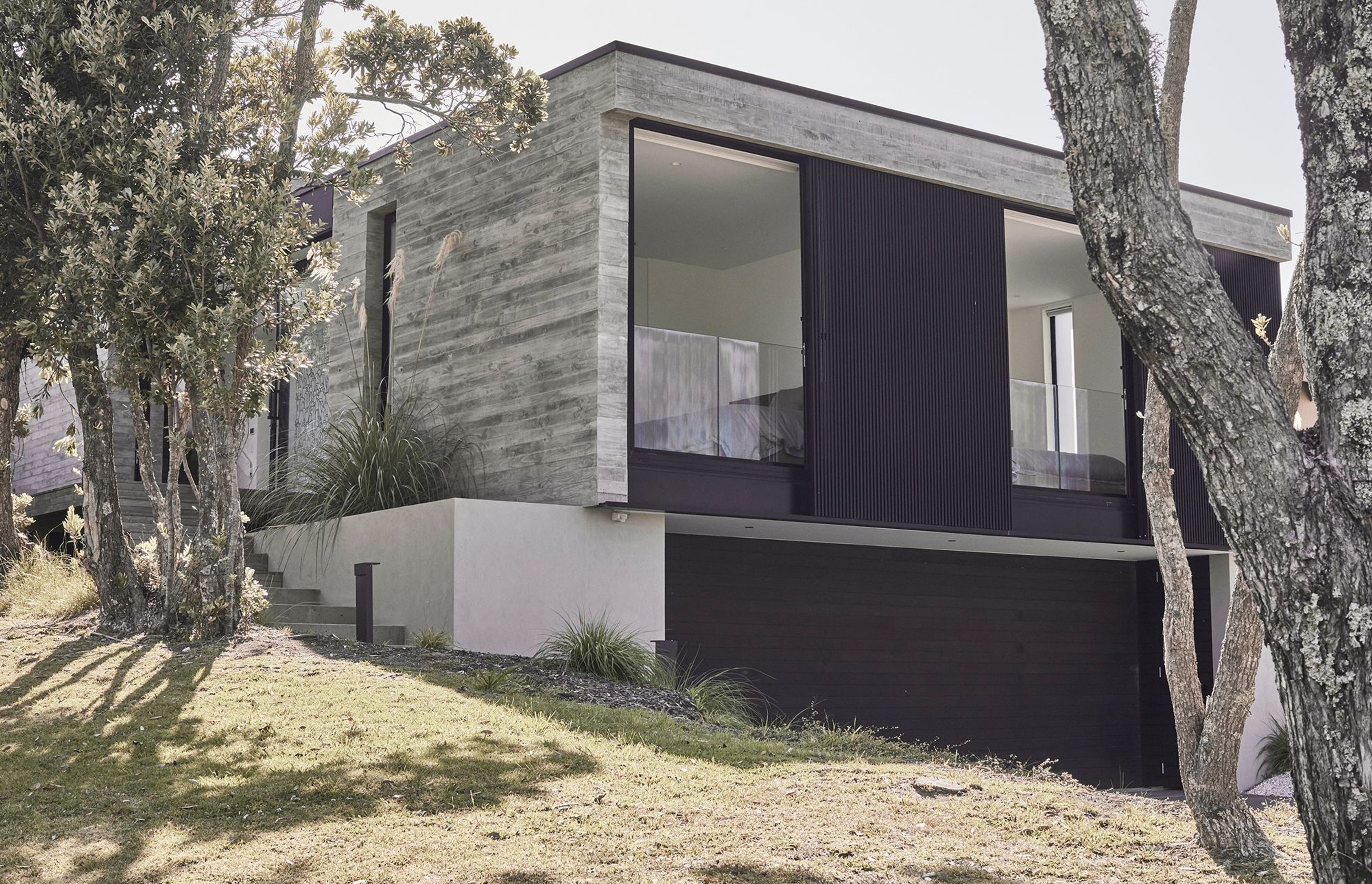 The simple structure of this holiday home is defined by the area’s rugged beauty of which the in situ concrete walls speak.