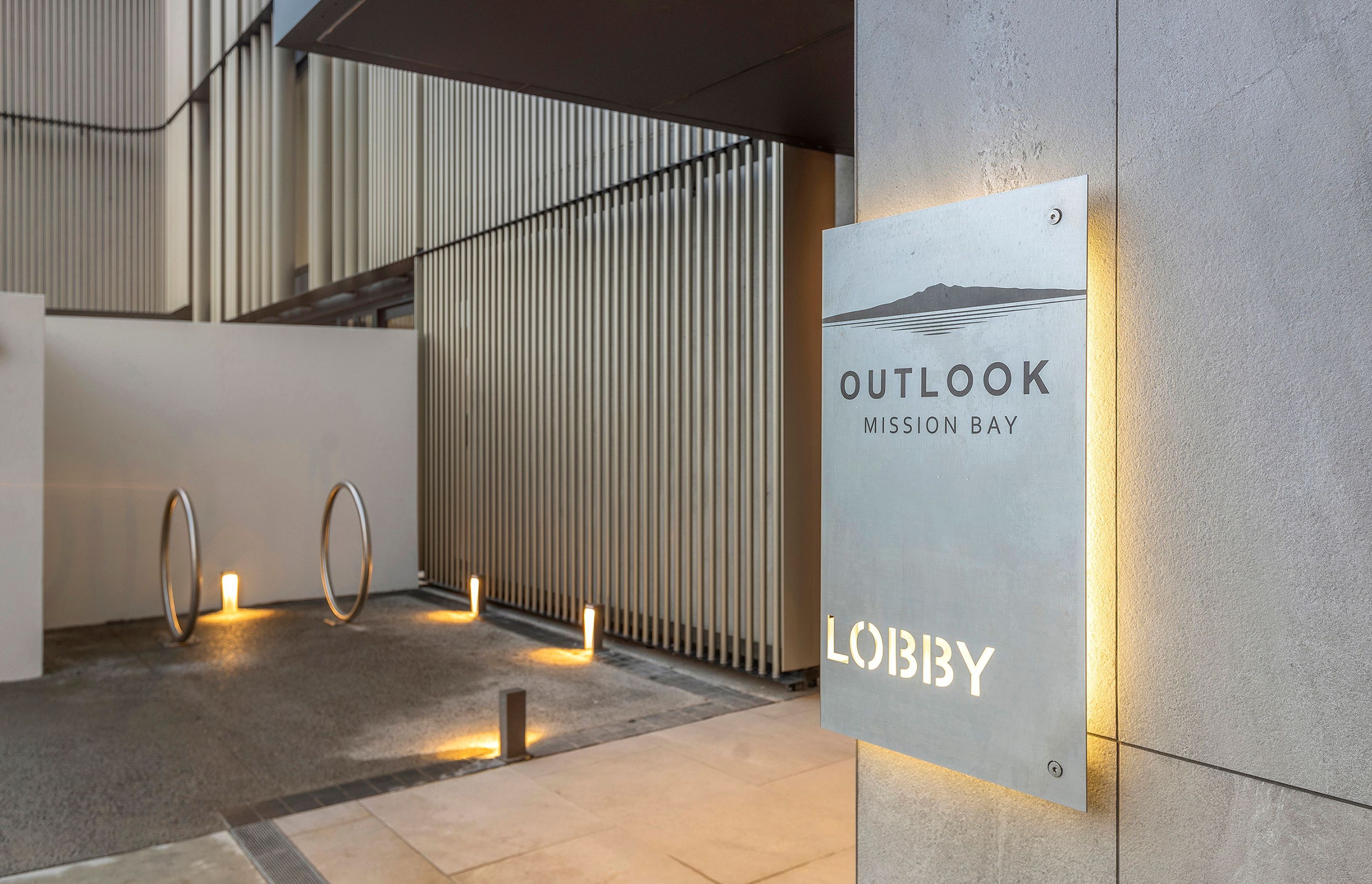 Exterior lighting is minimal with the extensive glazing creating an exterior that is lit from within; at night, and in the sun the aluminium screens shimmer in the light reducing the dominance of the five-storey building in its residential context.  