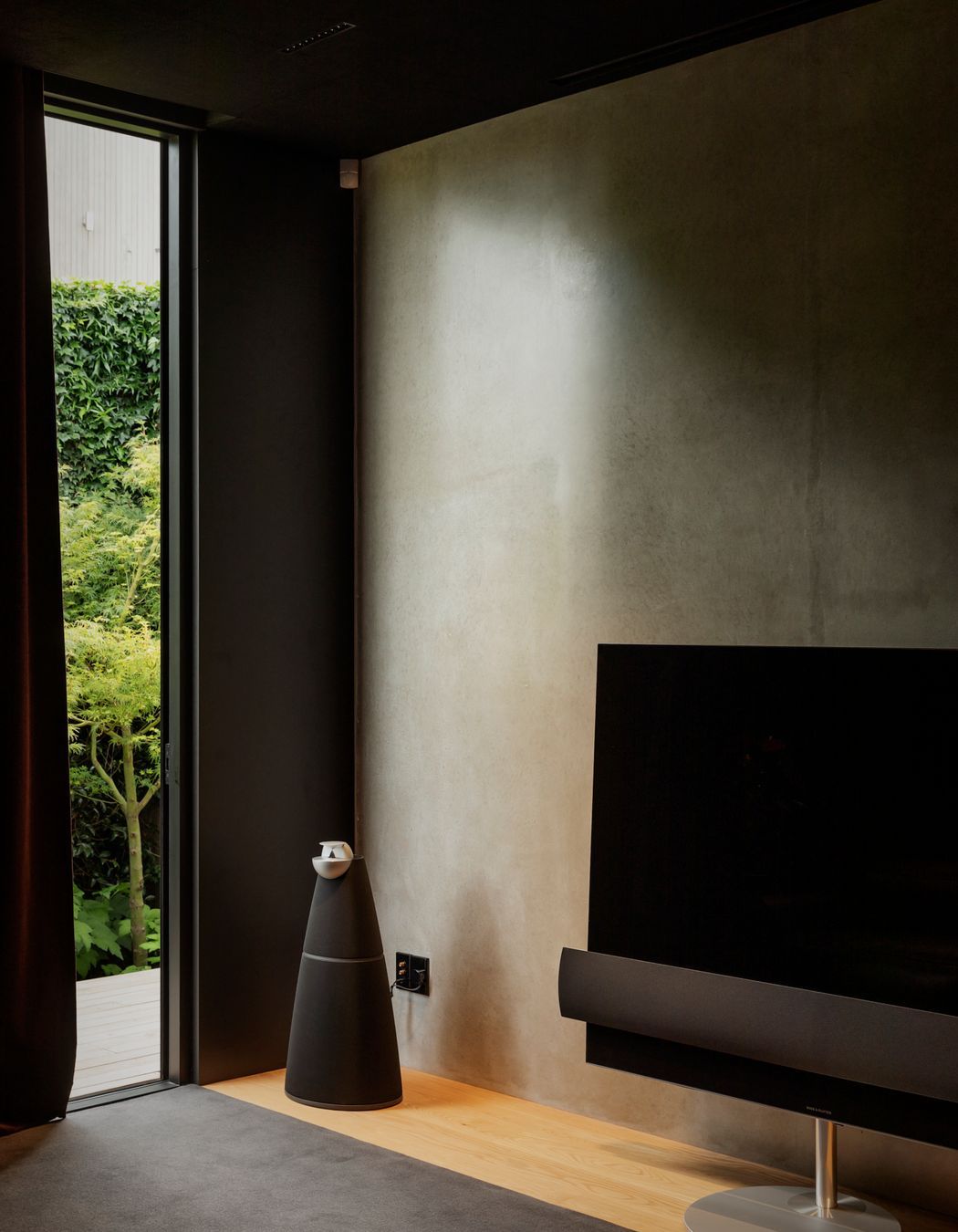 The media room at the rear of the house opens into a rear courtyard.