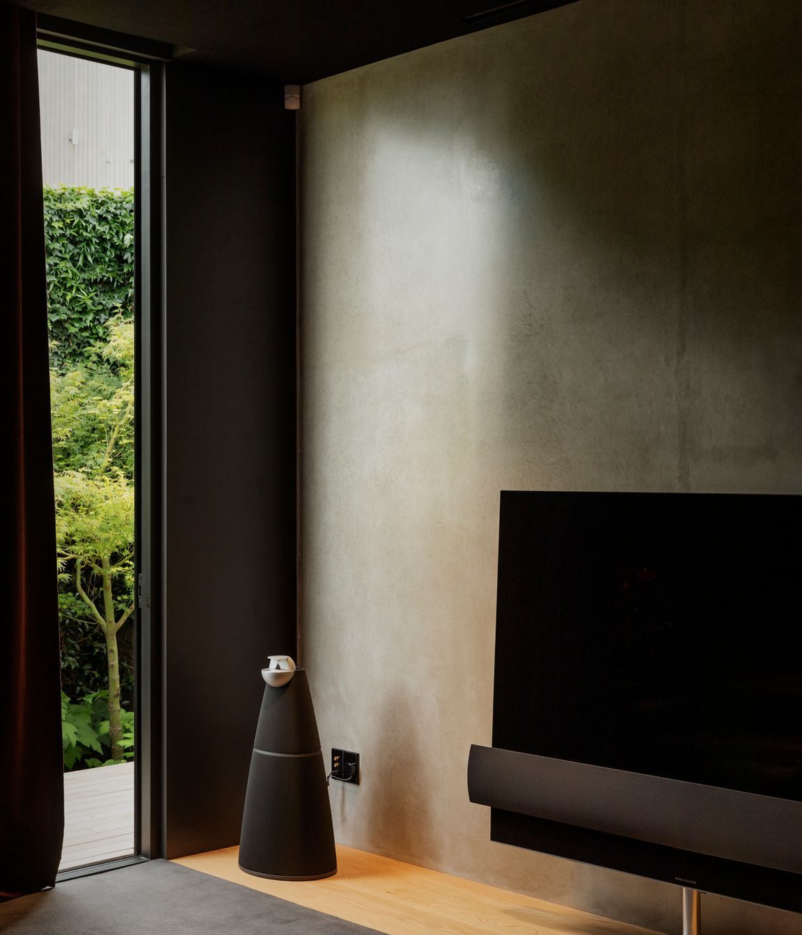 The media room at the rear of the house opens into a rear courtyard.