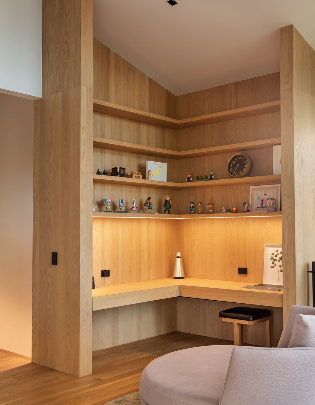 The study features built-in oak cabinetry with hidden drawers in the benchtop.