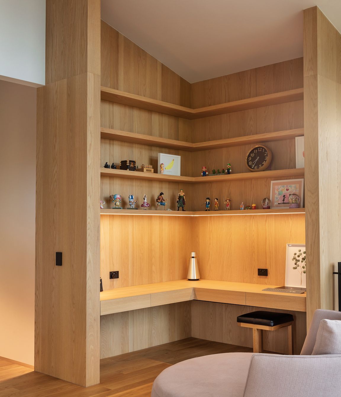 The study features built-in oak cabinetry with hidden drawers in the benchtop.