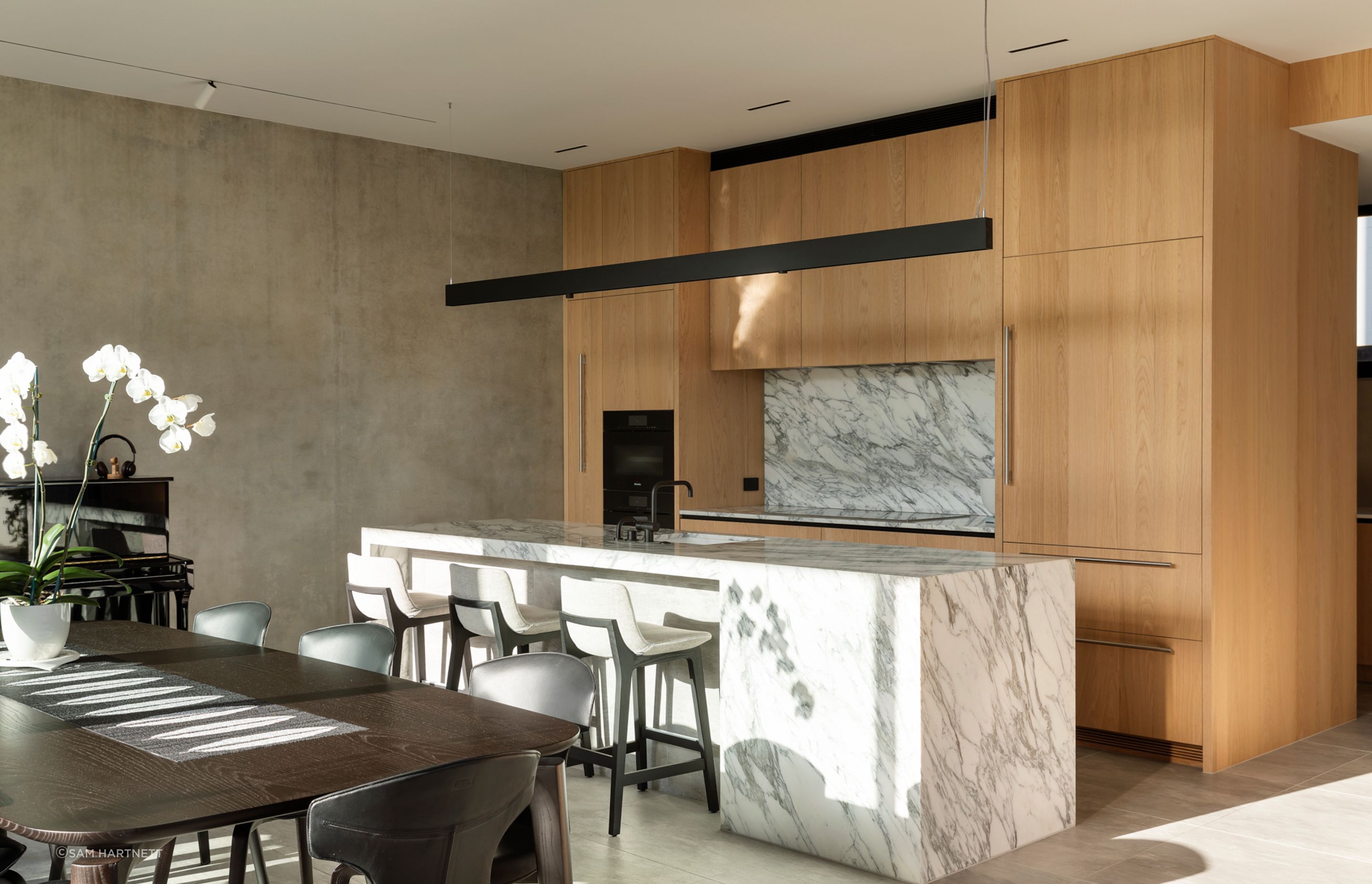 A classic Kiwi galley-style kitchen was designed for Asian cooking with a full chef's set-up in the discreet scullery in behind.