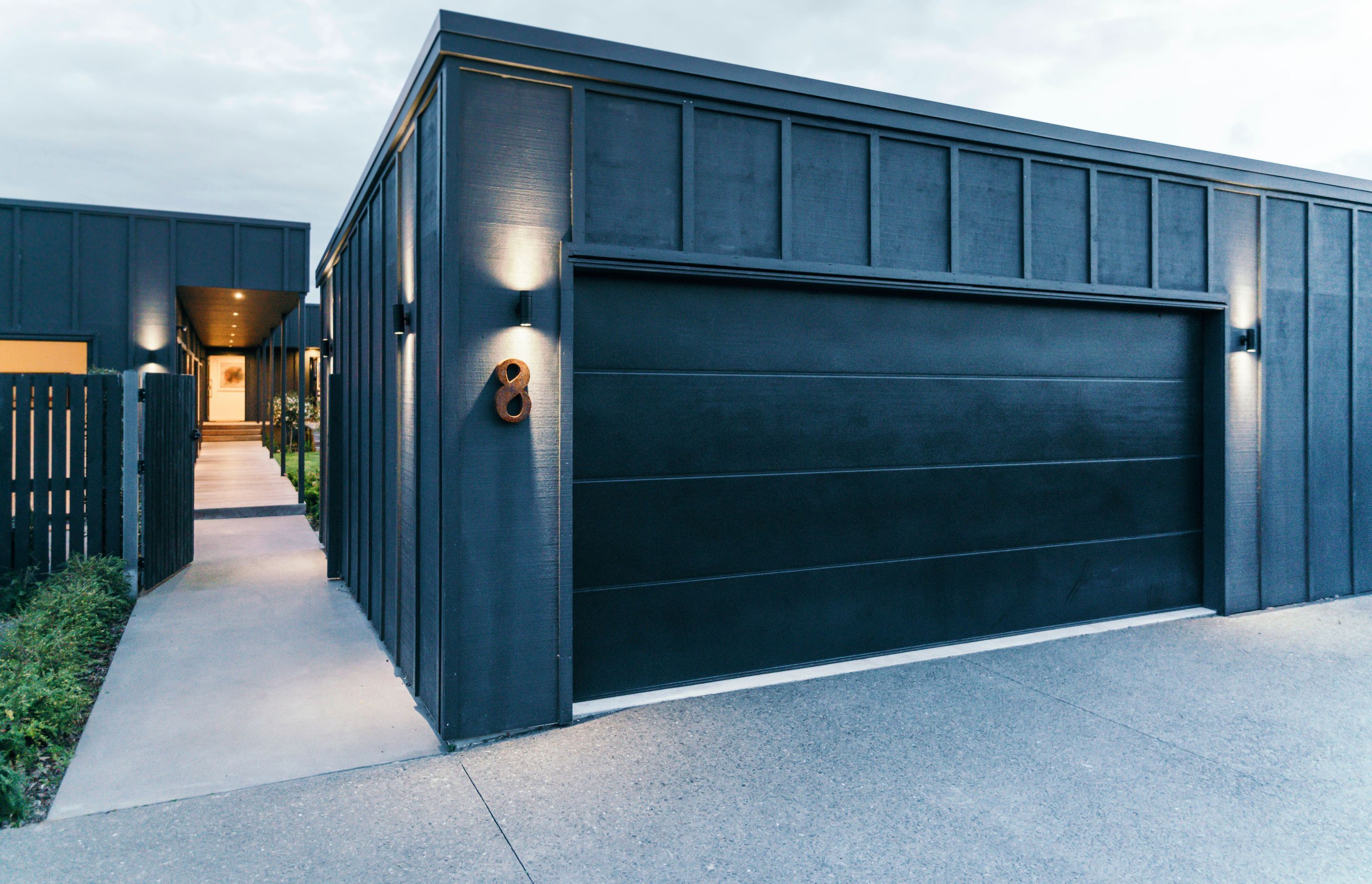 The new garage was placed in front of the property to act as a buffer between the house and the street and also to create an enclosed, internal courtyard.