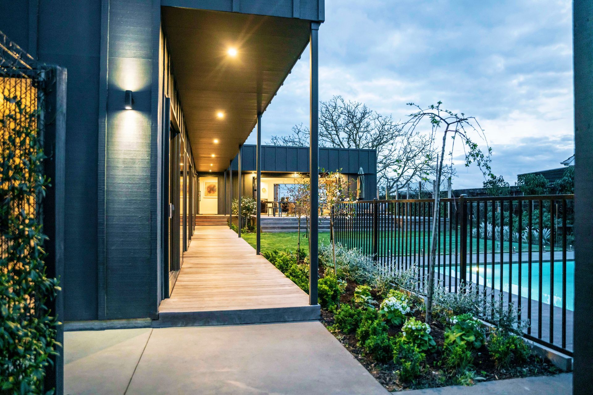 The new, north-facing courtyard features a swimming pool, lawn and large entertaining deck.