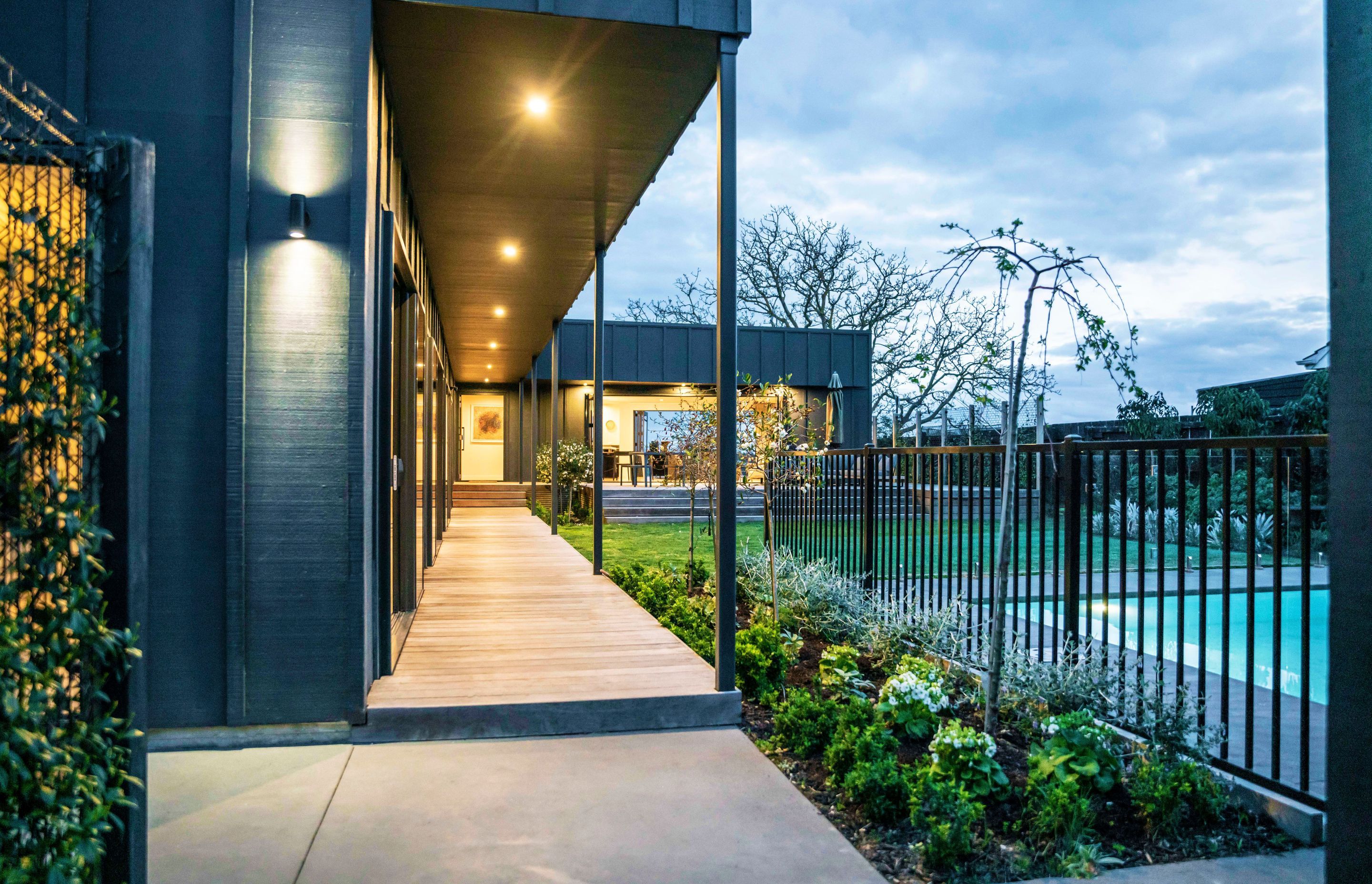 The new, north-facing courtyard features a swimming pool, lawn and large entertaining deck.