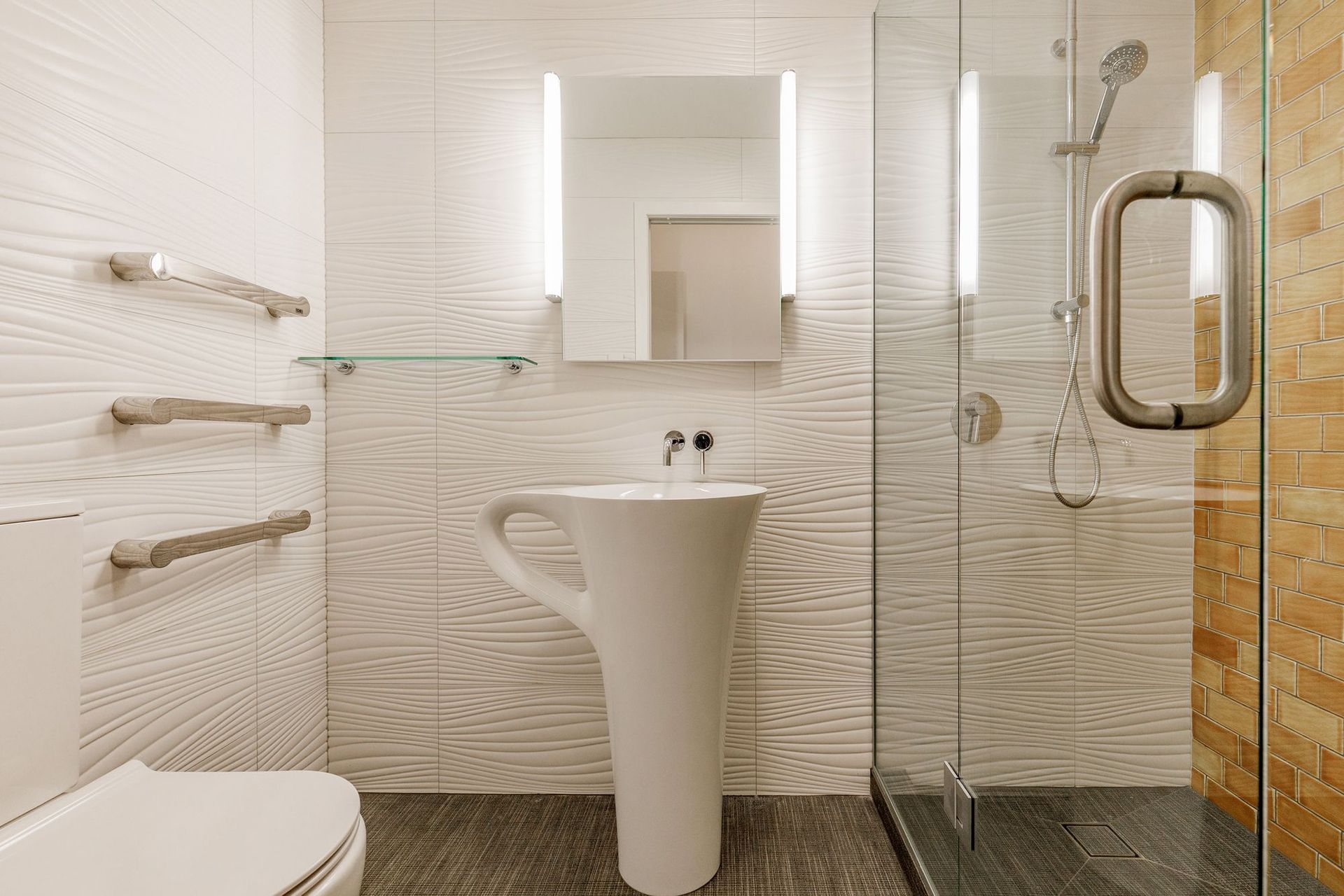 All elements for this guest bathroom were chosen to reflect a sense of relaxation with the connection to sun, sand and water in mind. MIDDLE EARTH TILES GOLDEN MANUKA 150 X 75 SUBWAY TILE LAID WITH 33% OFFSET were chosen to reflect the colour of the sun. TILE SPACE DUNES BLANCO MATT 300X900 POR094 600045 TO ALL OTHER BATHROOM WALLS was chosen to reflect waves and sand dunes. The tiles create such a wonderful look that is subtle yet still very interesting to look at. TILE SPACE TAILORART BROWN 600X600 CSA019 to the floor was chosen to reflect a textured fabric, like a blanket used on the beach.