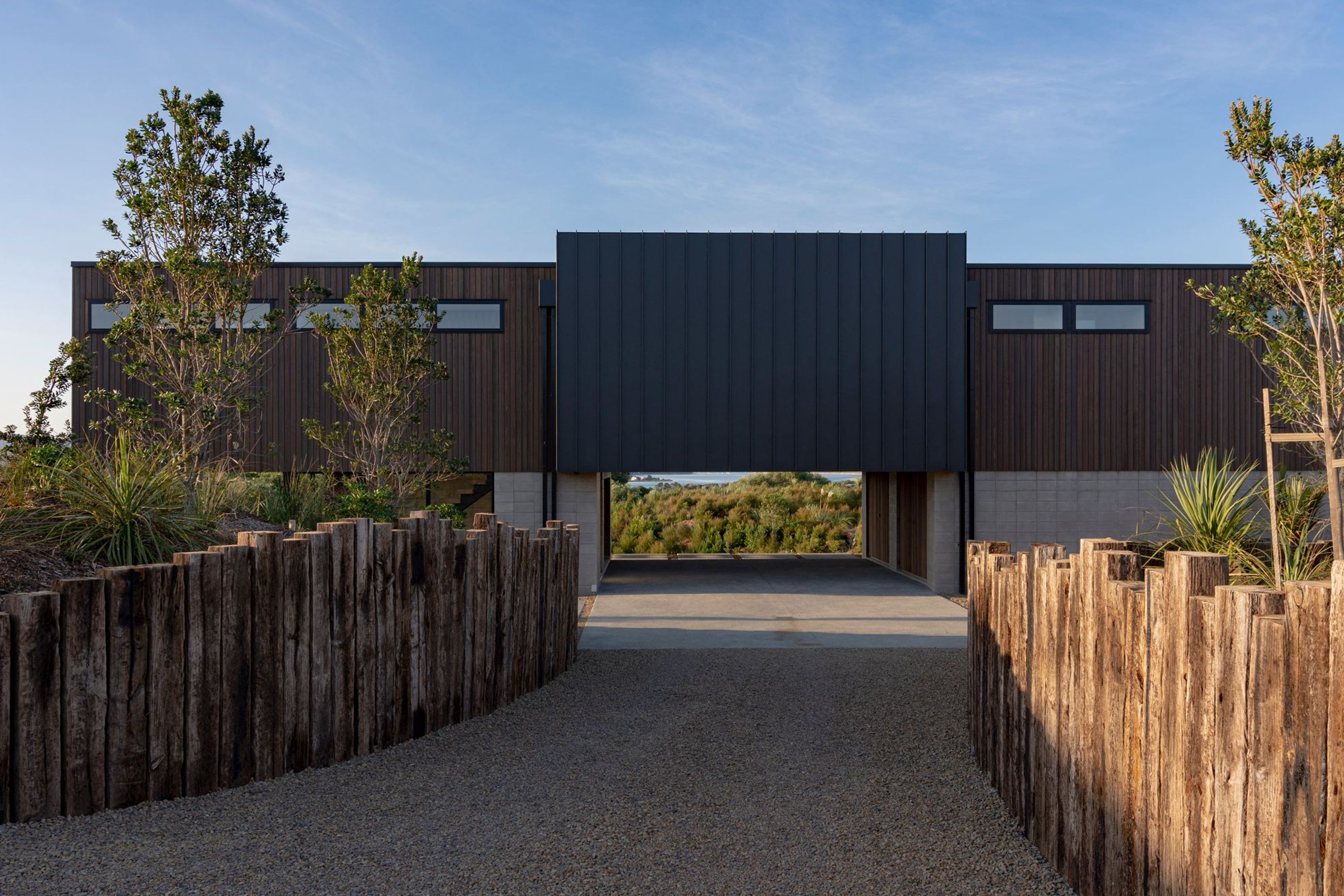 The view becomes visible on approach to the house through the central carved out area of the plinth which doubles as a semi-sheltered parking area. 