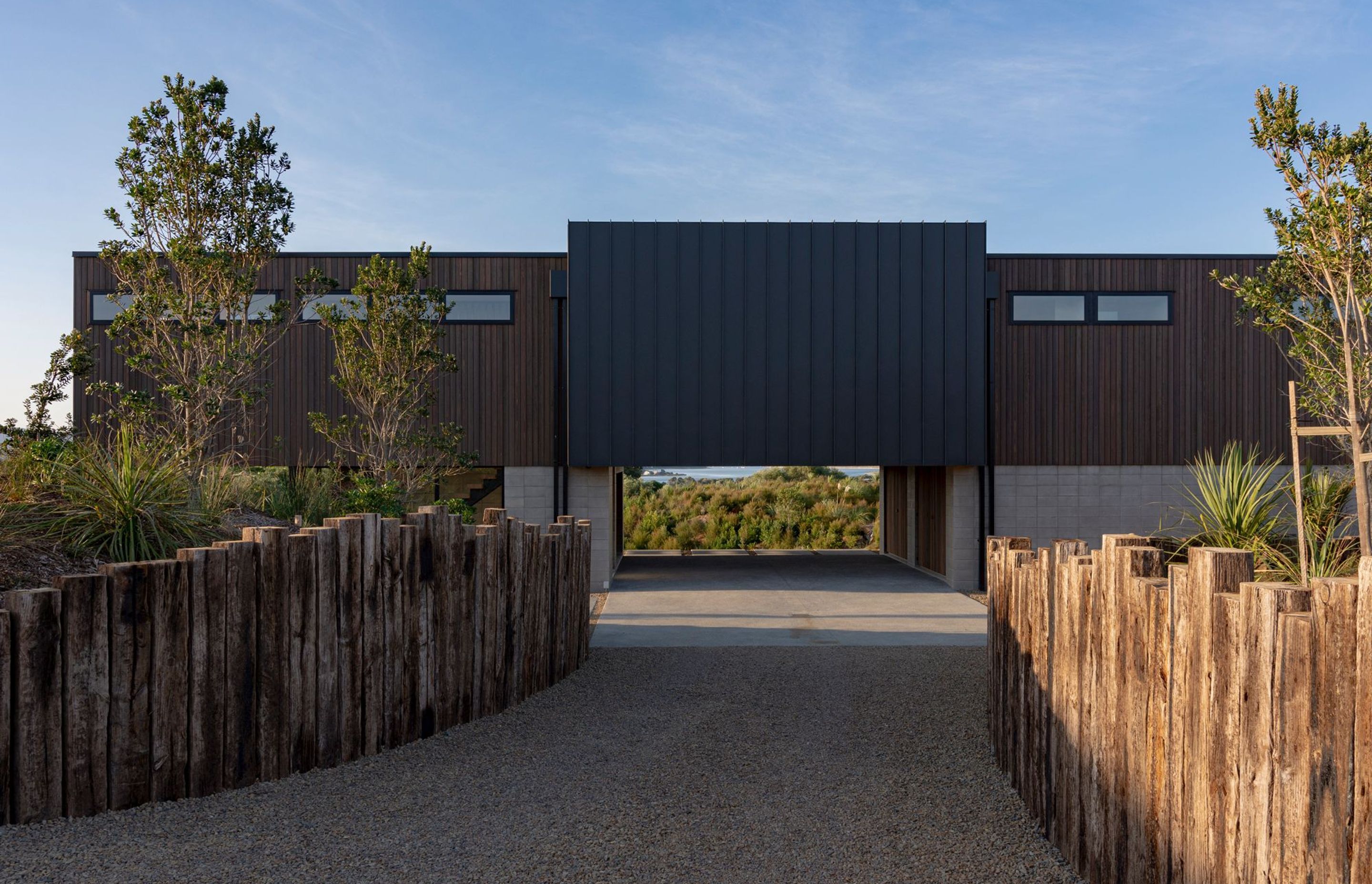 The view becomes visible on approach to the house through the central carved out area of the plinth which doubles as a semi-sheltered parking area.