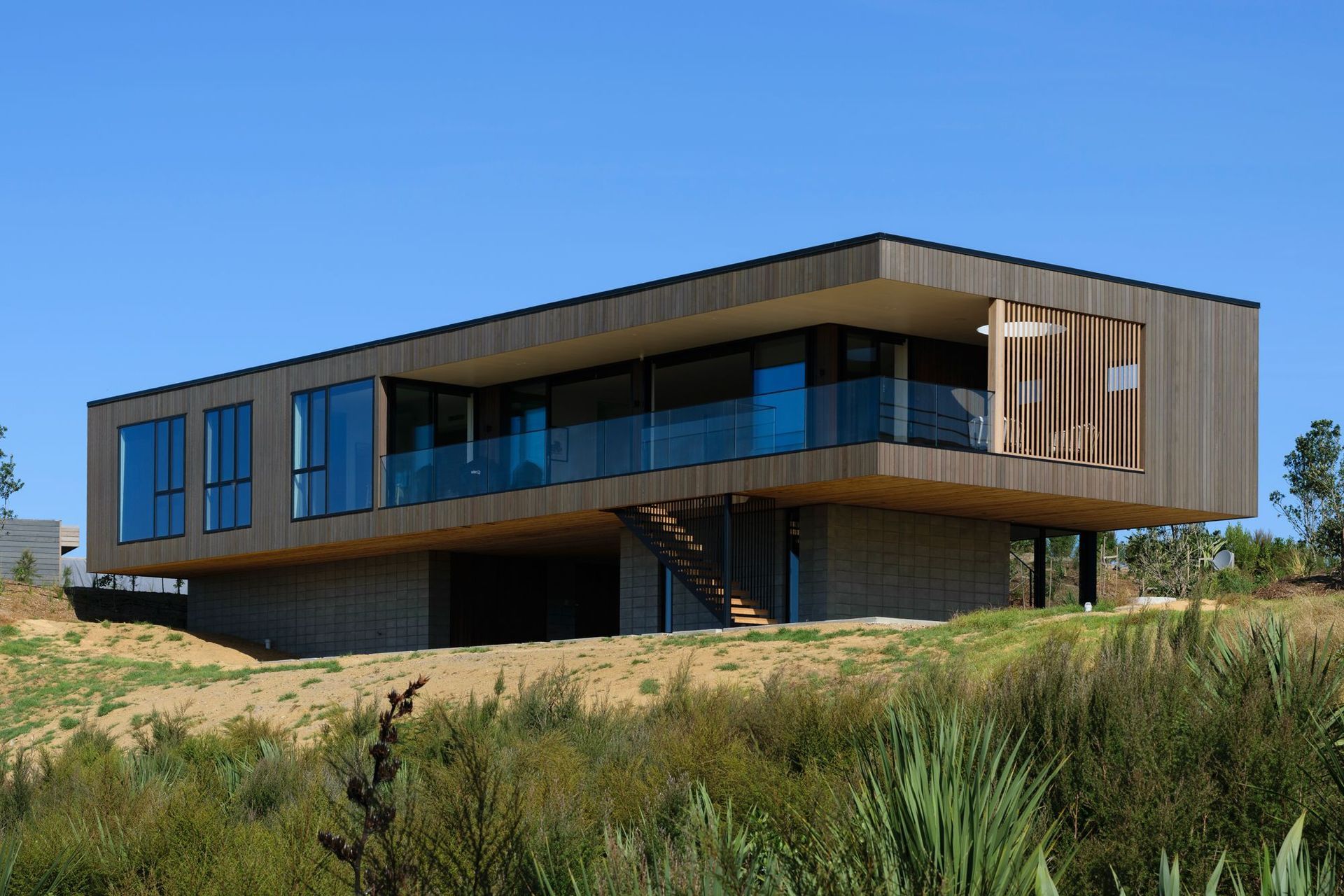 Decks to the north and west are carved out of the simple rectangular box form. 