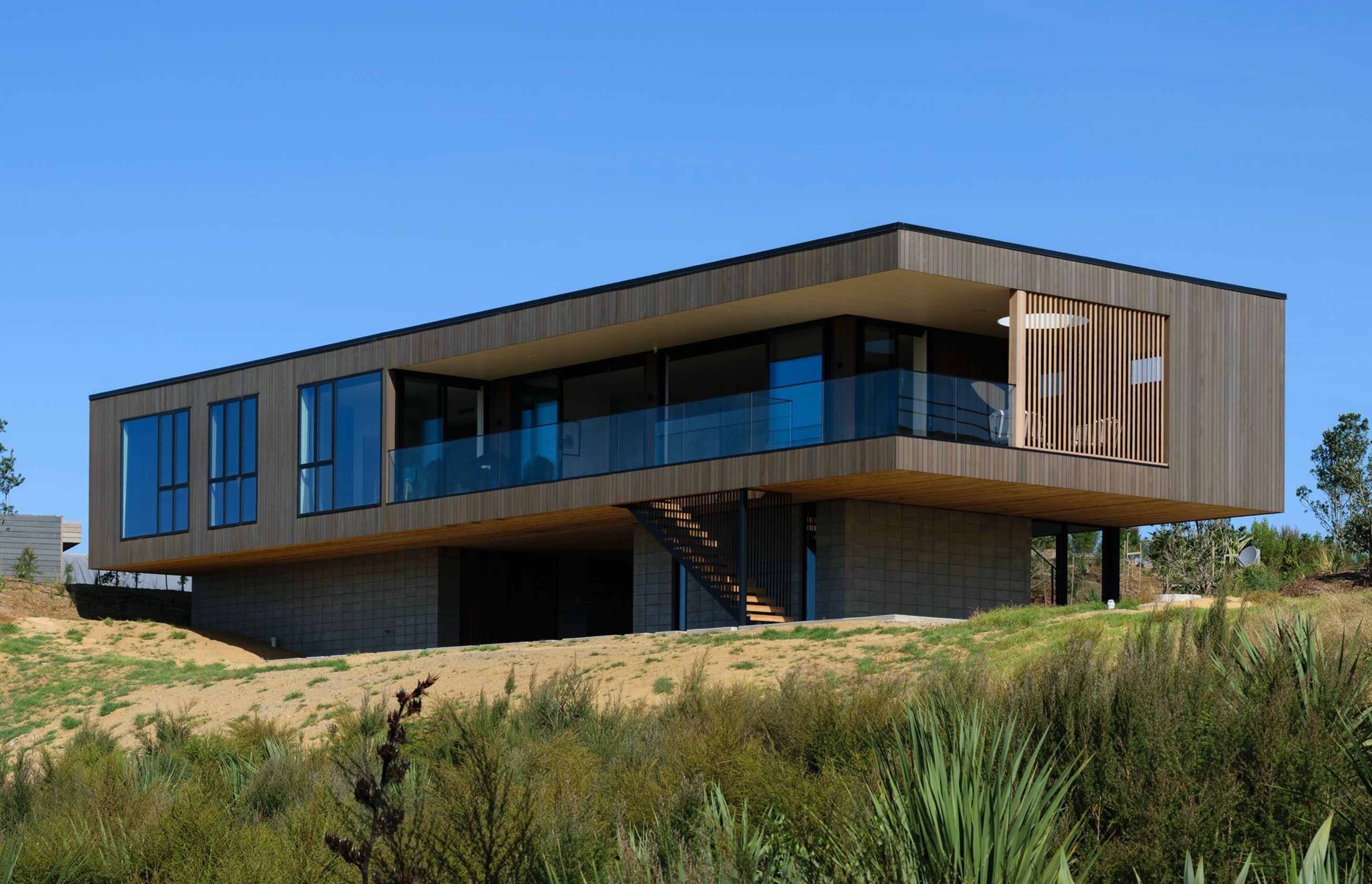 Decks to the north and west are carved out of the simple rectangular box form.
