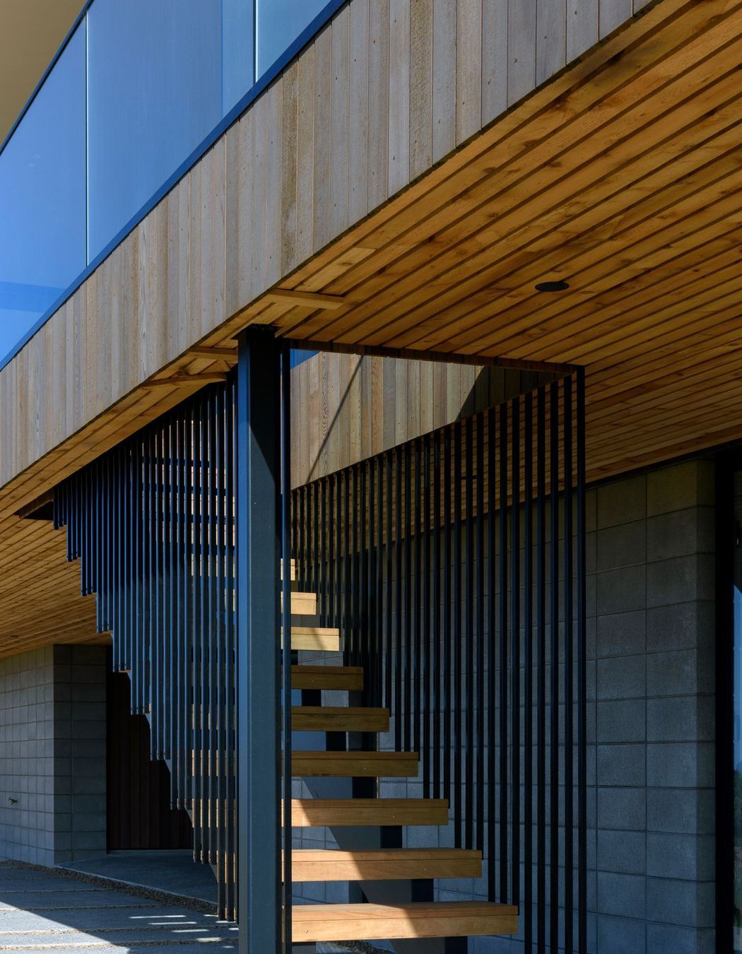 The concrete block plinth was left exposed and combined with vertical cedar on the upper level. 