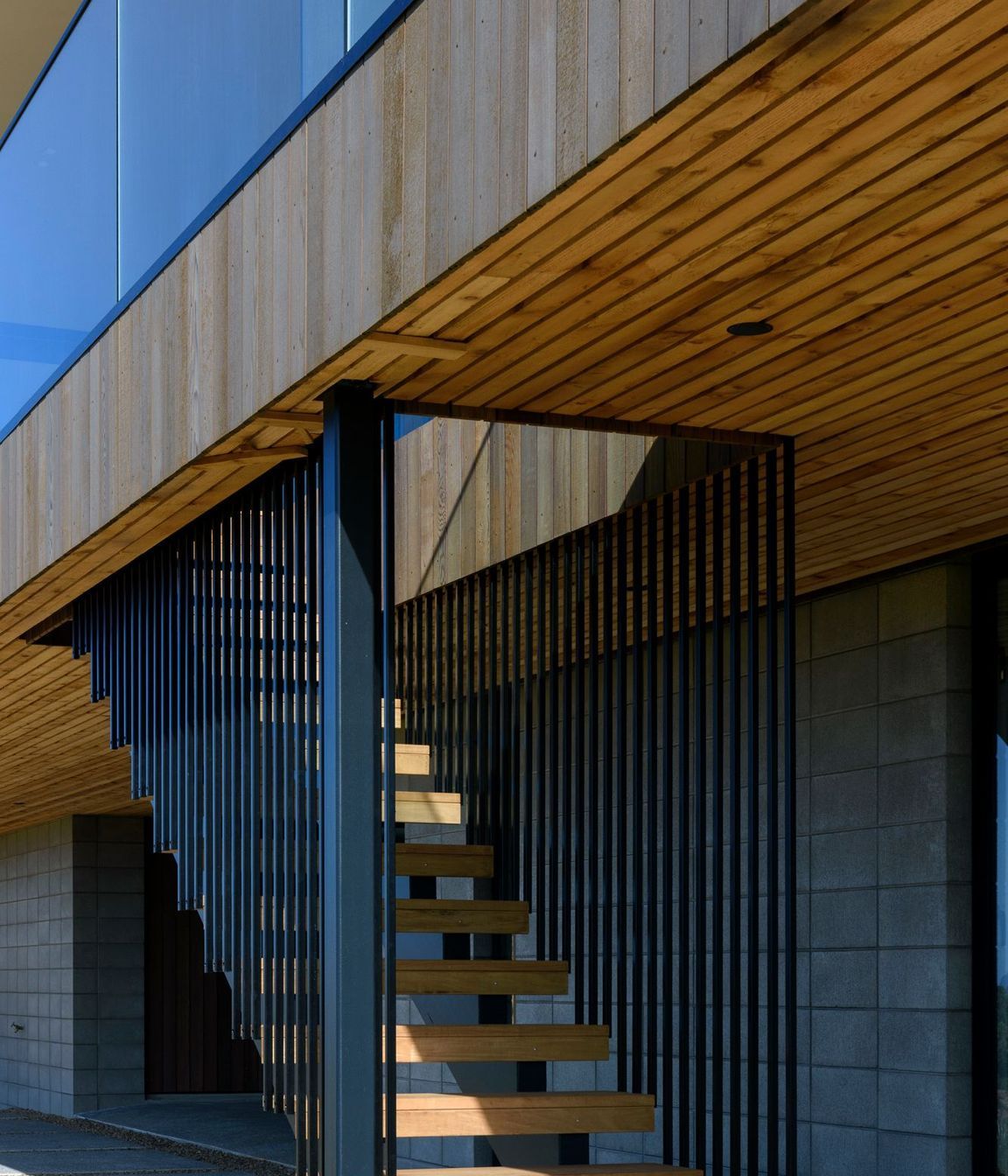 The concrete block plinth was left exposed and combined with vertical cedar on the upper level. 