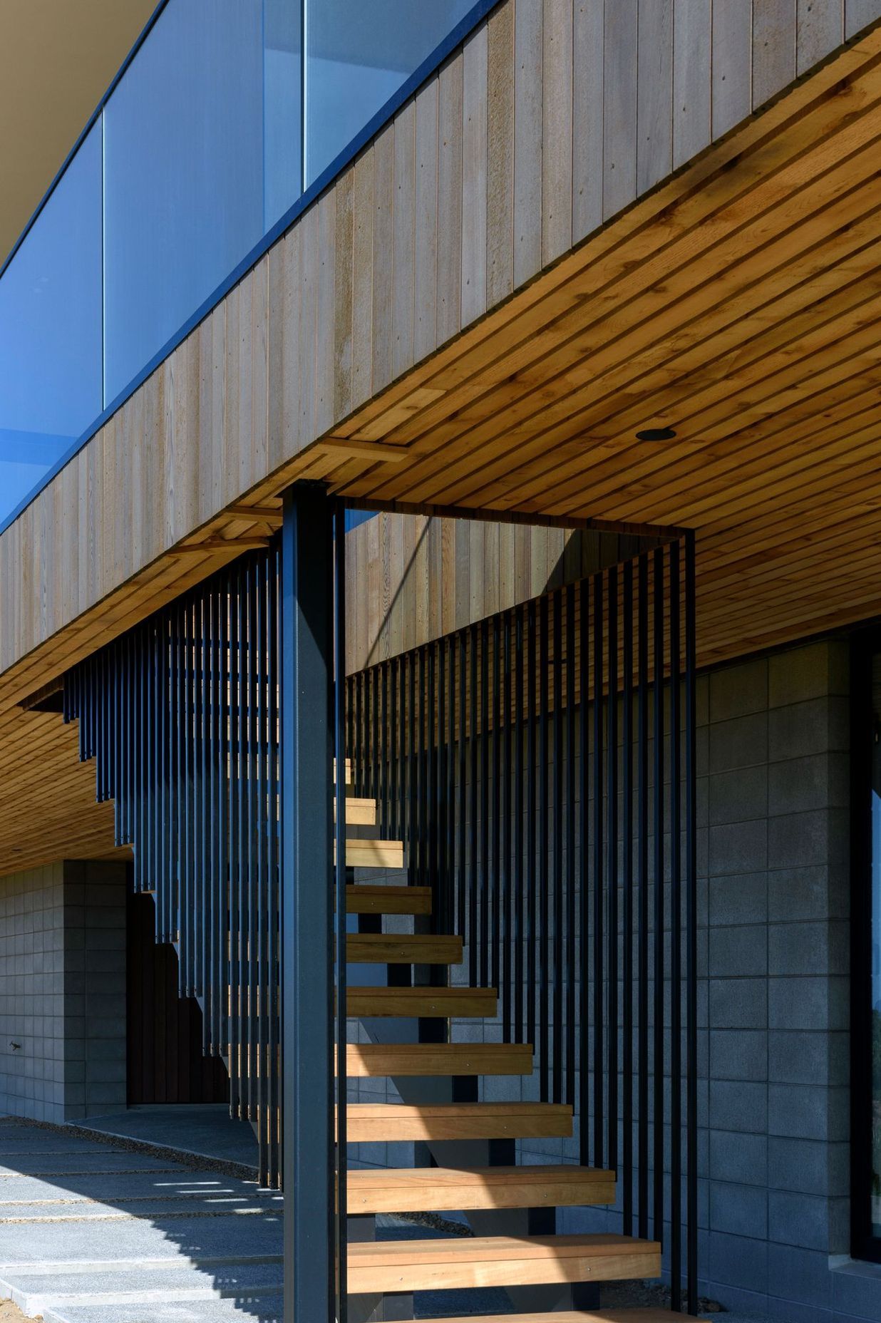 The concrete block plinth was left exposed and combined with vertical cedar on the upper level. 