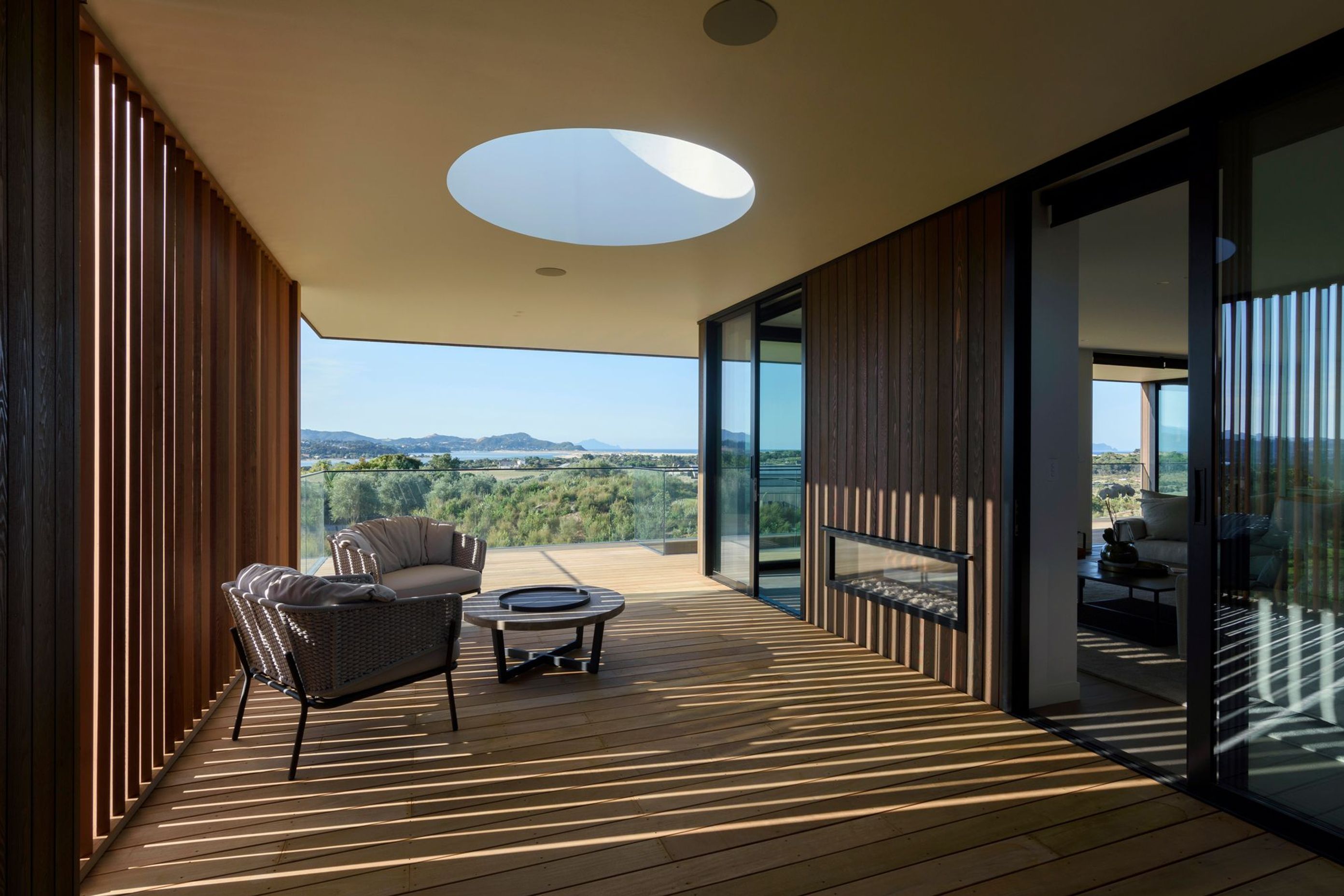 A skylight above the western deck draws light into the area while cedar fins create changing patterns throughout the day. 