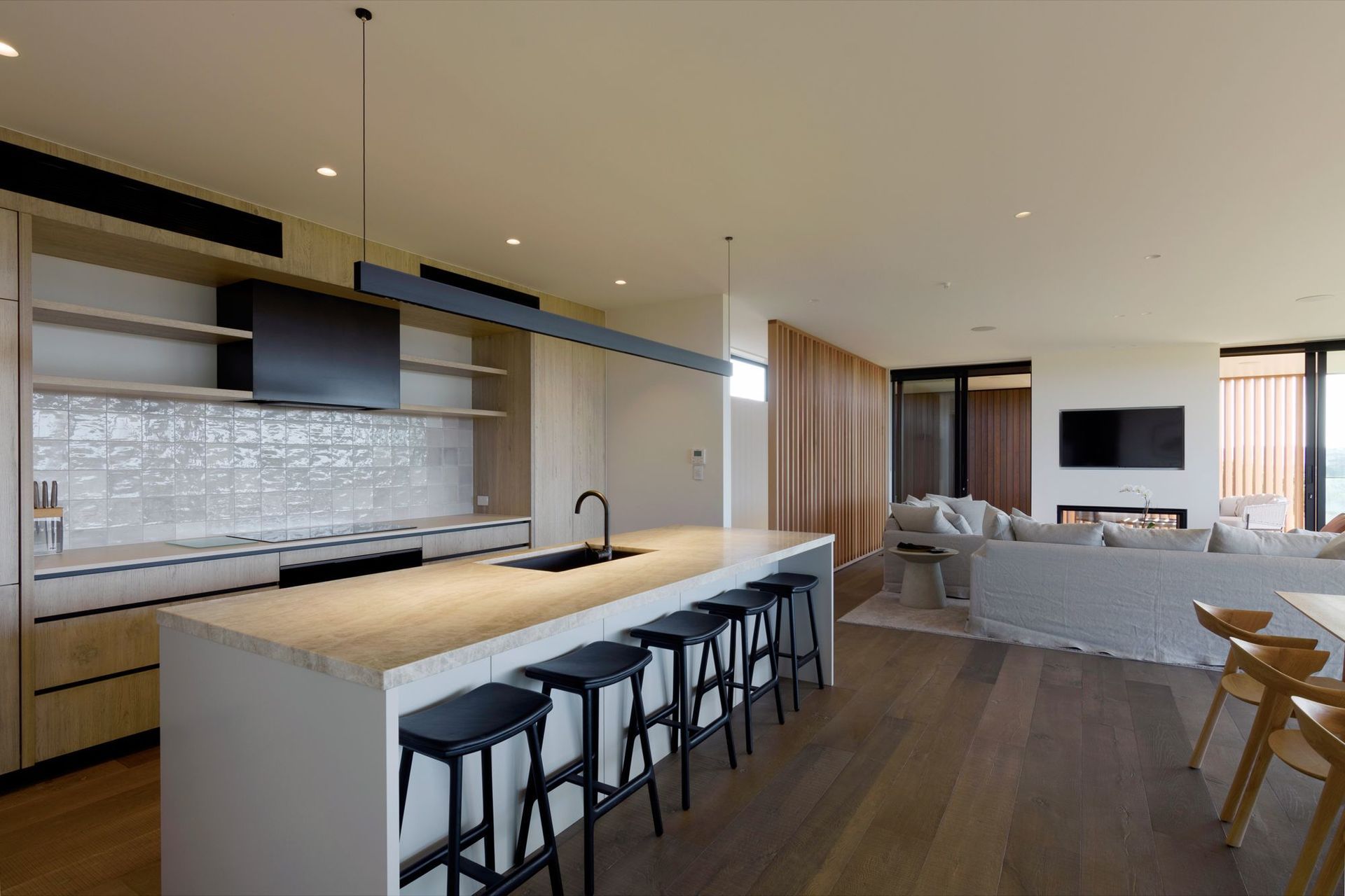 A pared back colour and material palette enhances the coastal setting.