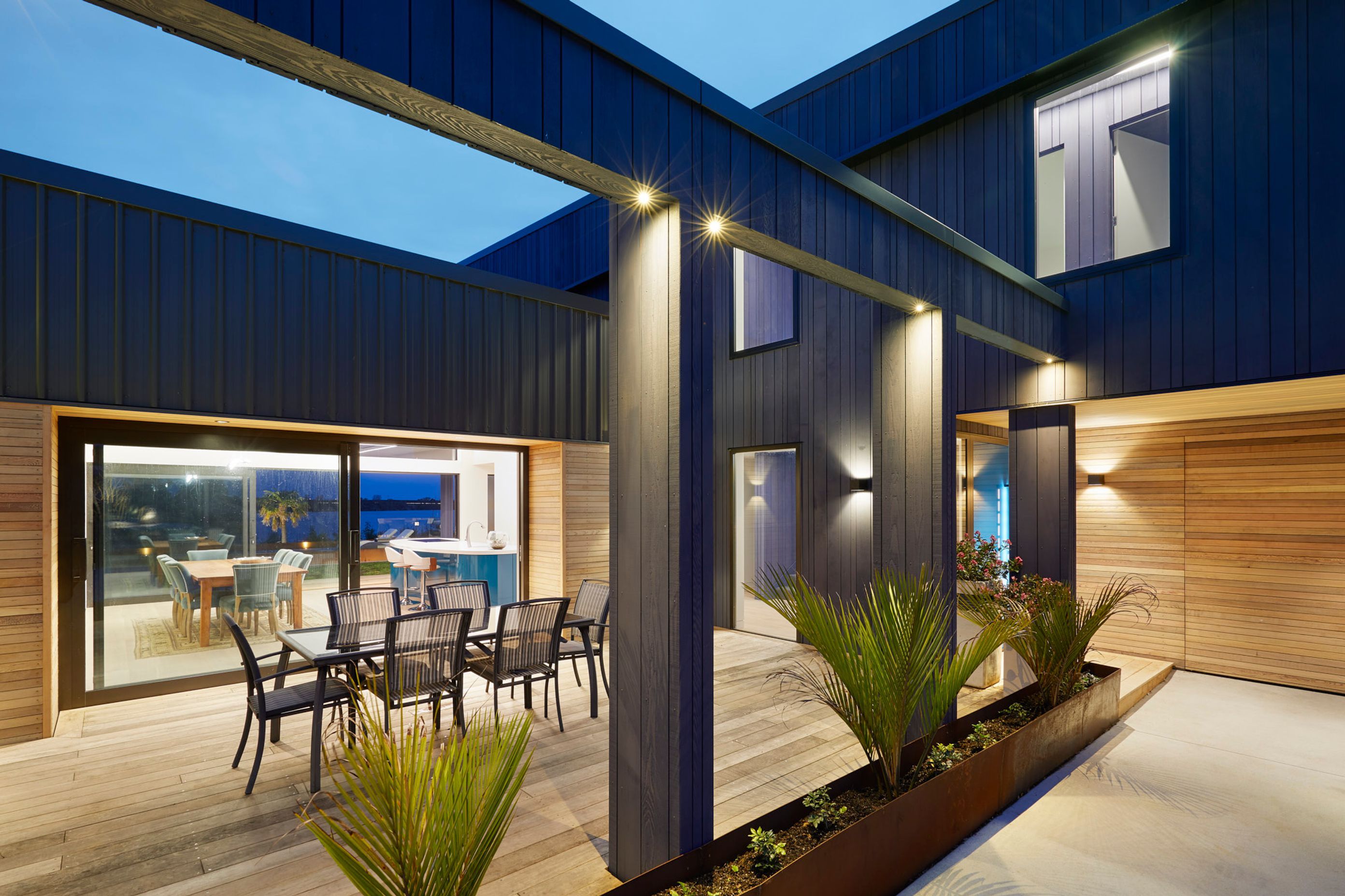 The three bedroom, two bathroom home is built for lifestyle and entertaining with open plan kitchen, living and dining opening out onto three covered outdoor areas and a stunning pool with surrounding deck built into the landscape and surrounded by Corten