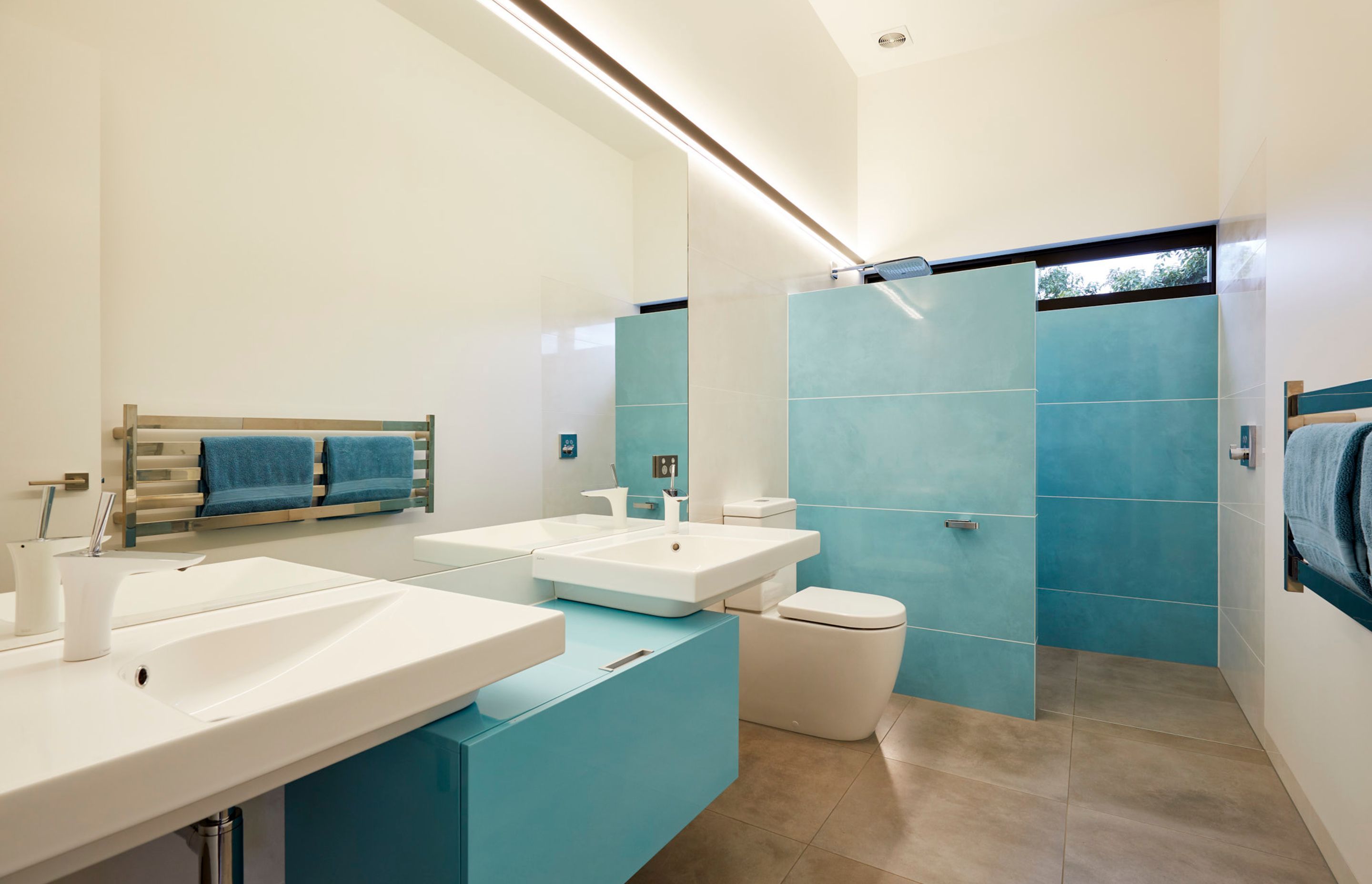 Sophisticated bathroom makes good use of the full solar power system with battery storage and underground storage tanks for collecting the roof water.