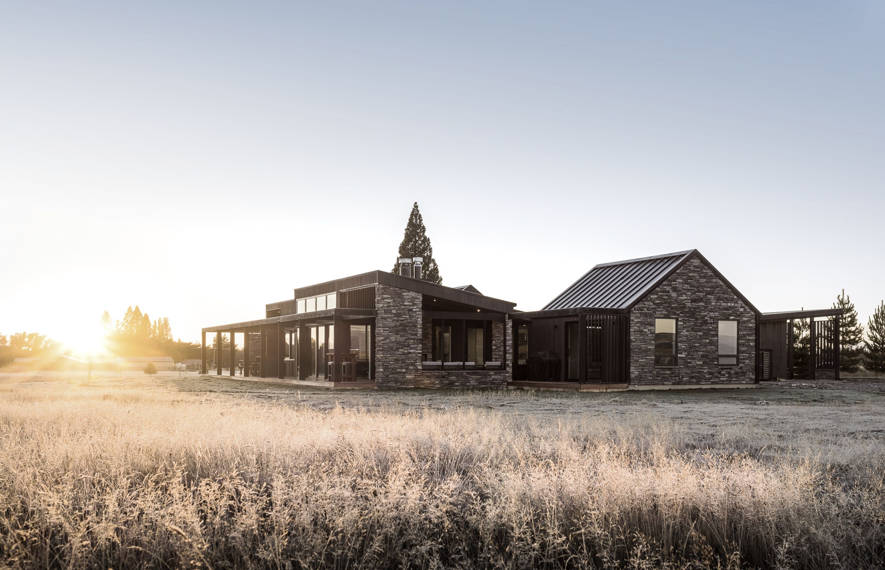 The form of the building is simple with a long, gable-framed barn-like structure through the centre and monopitched wings to the north and south.