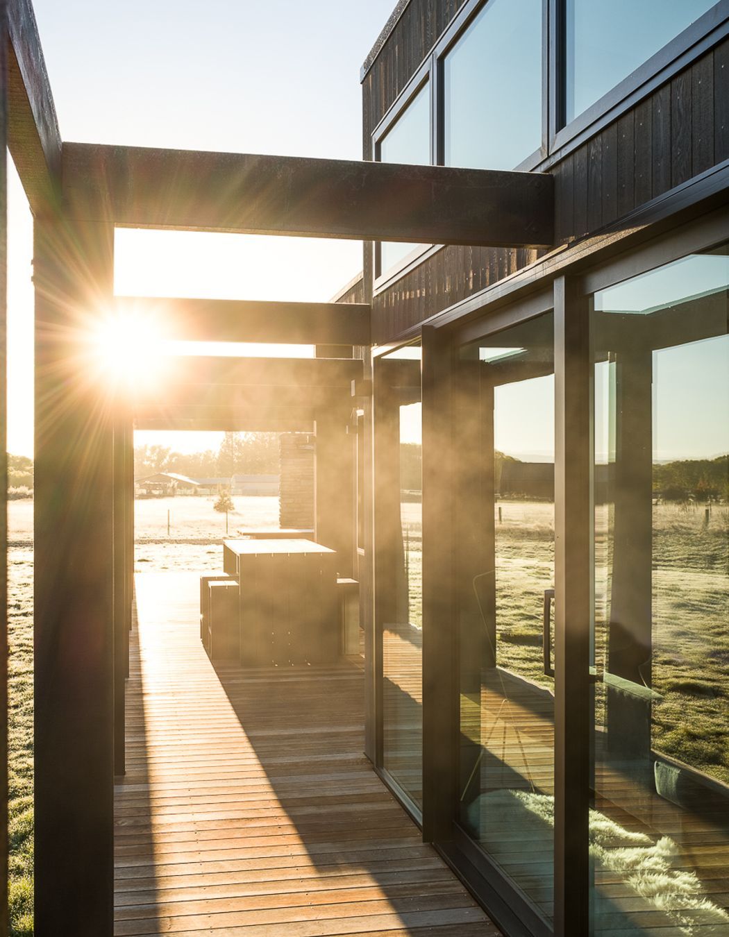The pergola structure acts like a brise soleil to reduce heat gain by blocking out harsh solar rays in the summer and allowing winter light to penetrate, all while keeping all-important sightlines open