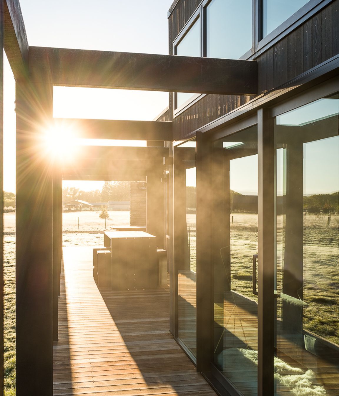 The pergola structure acts like a brise soleil to reduce heat gain by blocking out harsh solar rays in the summer and allowing winter light to penetrate, all while keeping all-important sightlines open